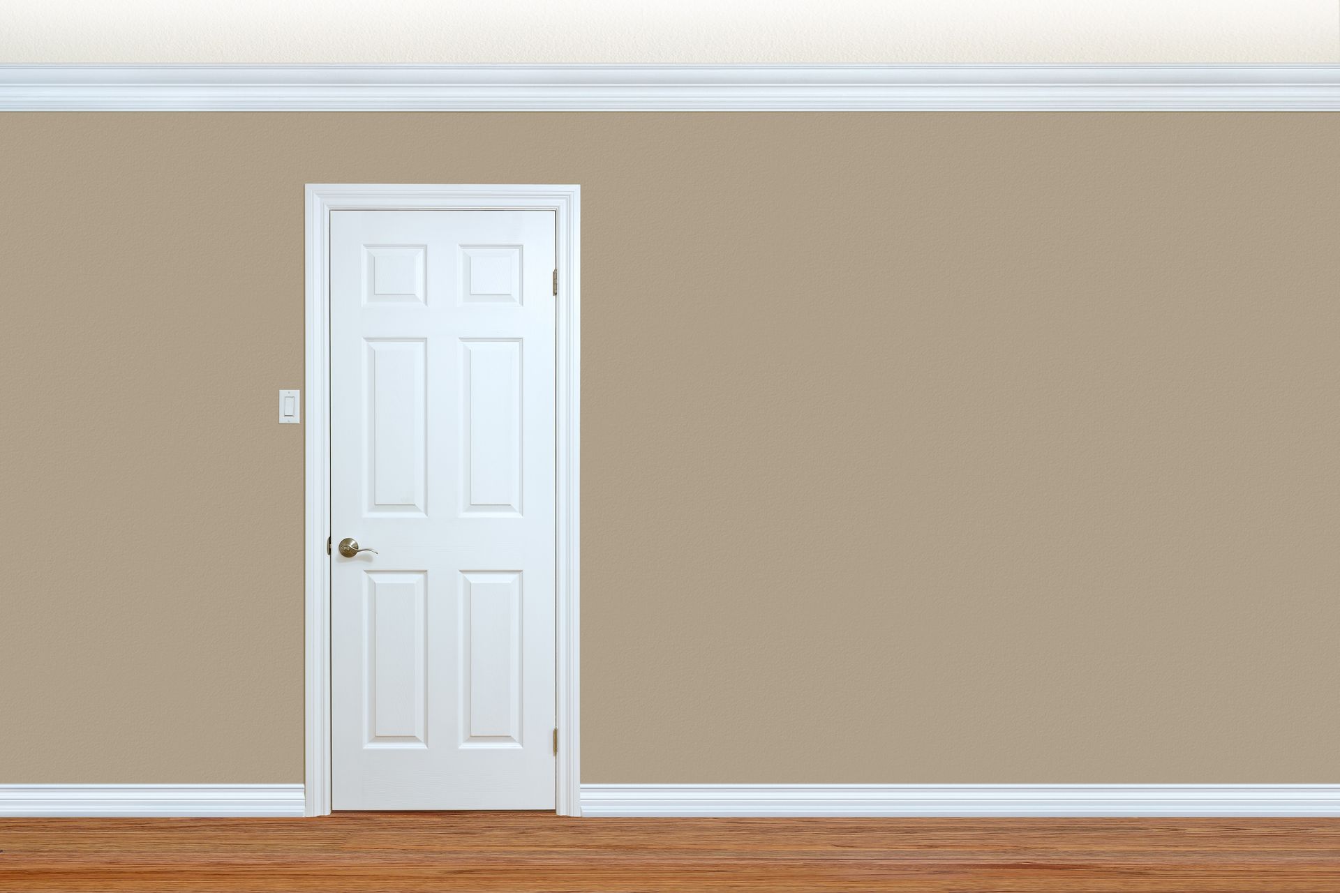 A well-decorated bedroom wall featuring a sleek door, elegant baseboard, and intricate crown molding.