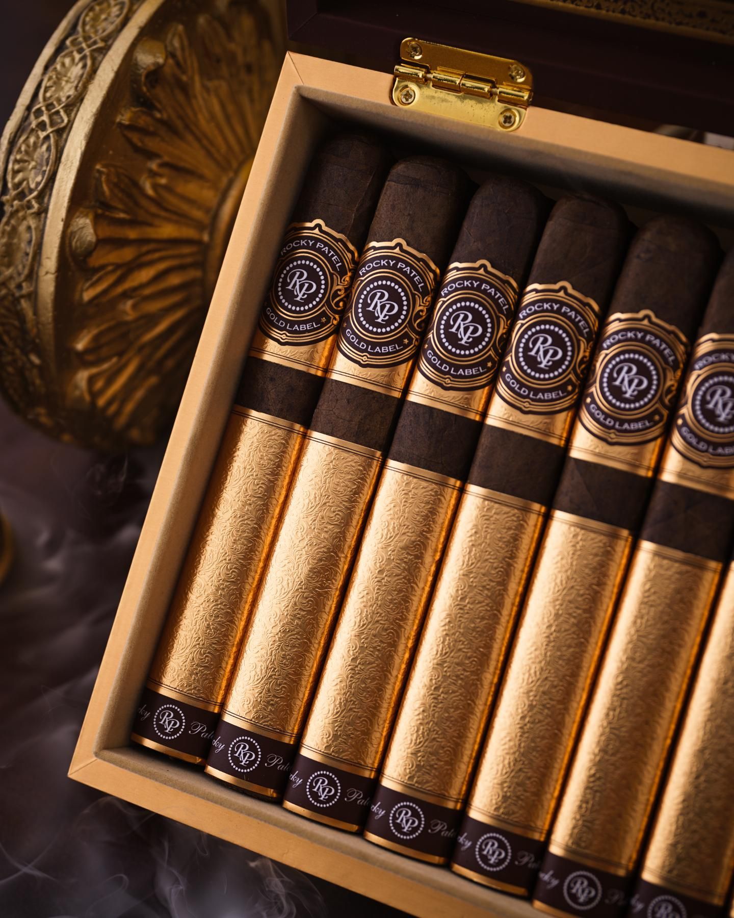Six gold-and-black books arranged in a decorative wooden box.