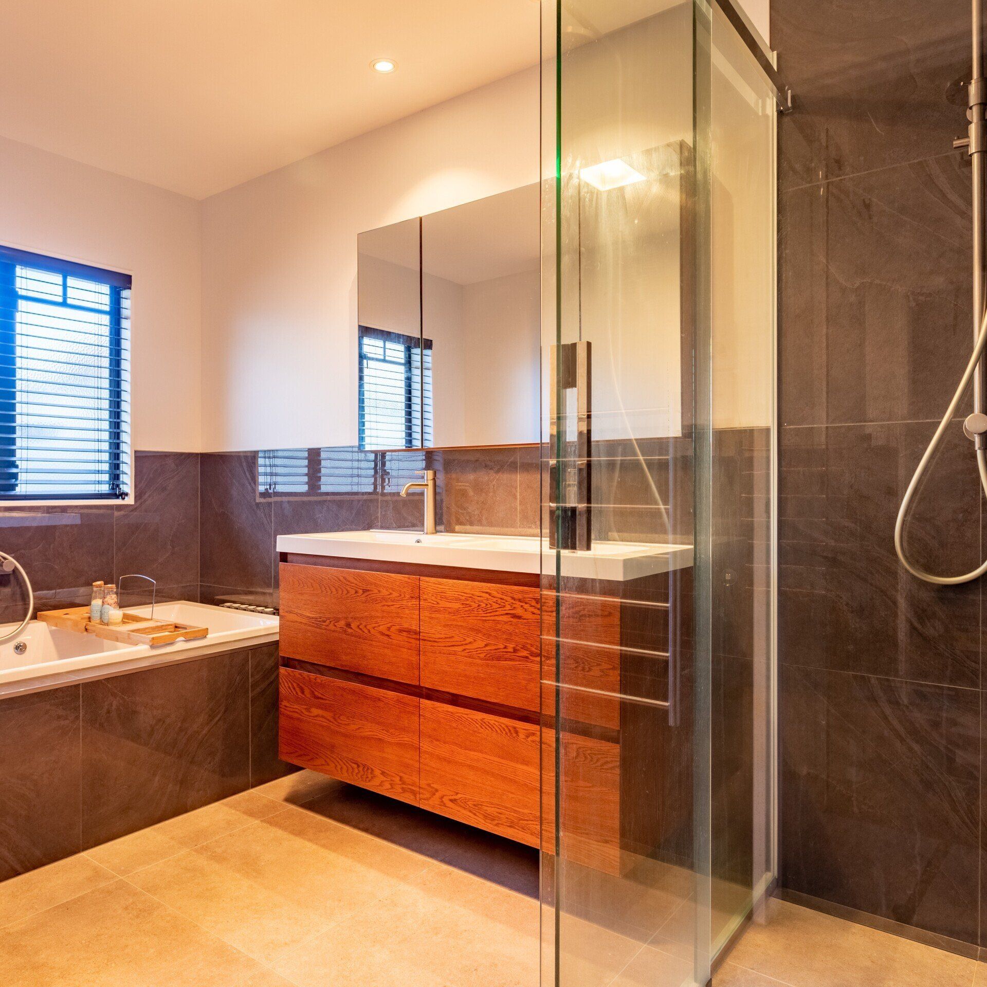A bathroom with a sink , tub , shower and mirror