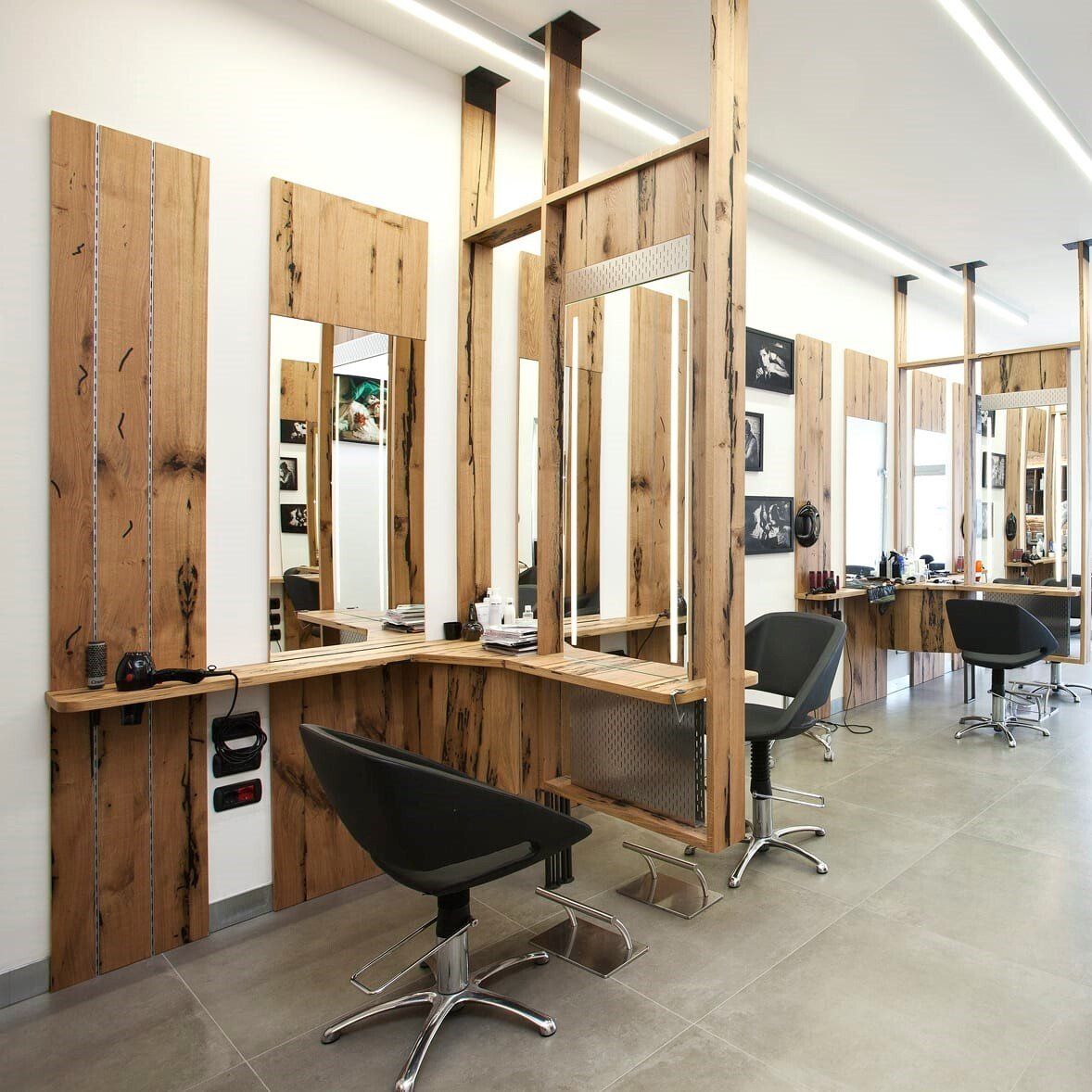 A hair salon with lots of chairs and mirrors