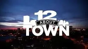 “12 About Town” logo over a twilight city skyline with purple-blue sky and city lights