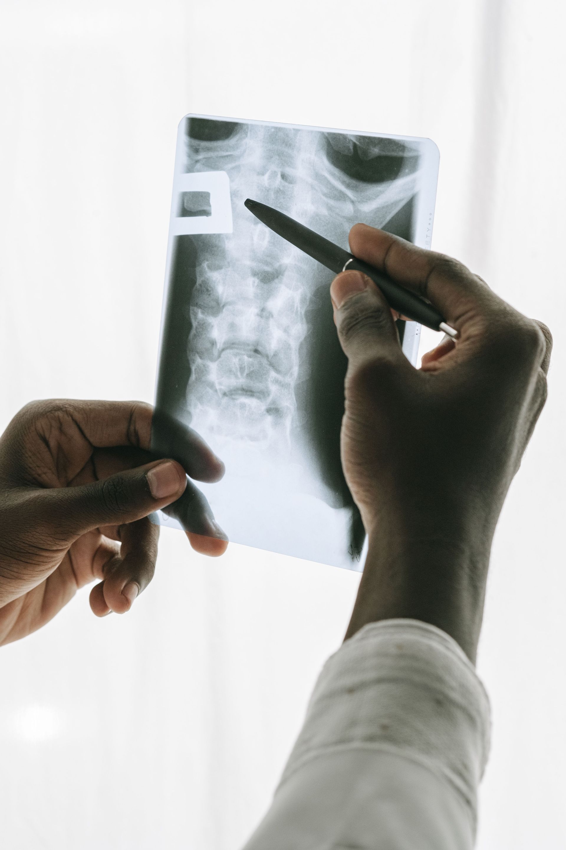 Chiropractor examining patient's neck and cervical spine