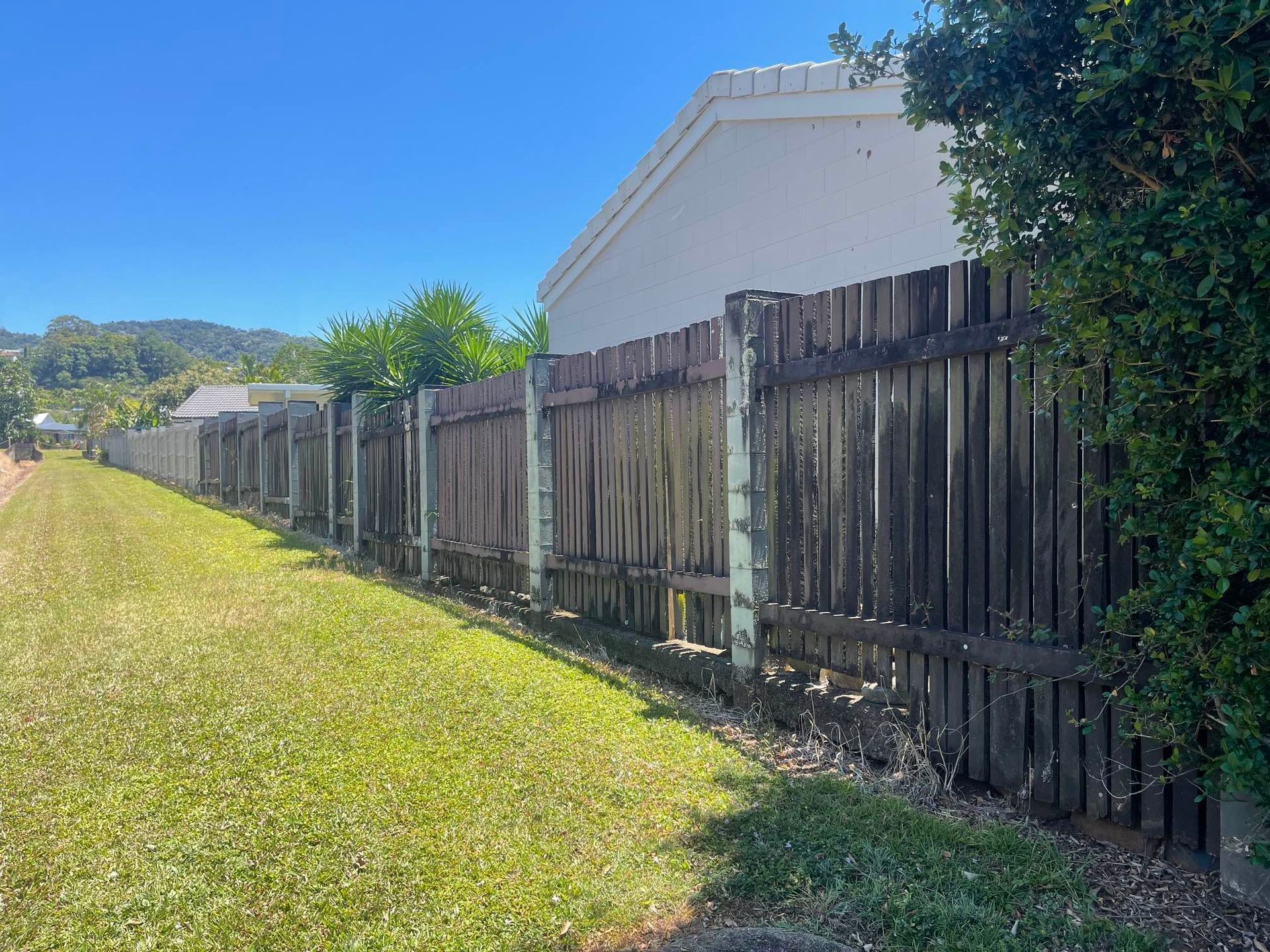 Two men are working on a fence around a swimming pool — Slim Fox Home Improvements in Mooroobool, QLD