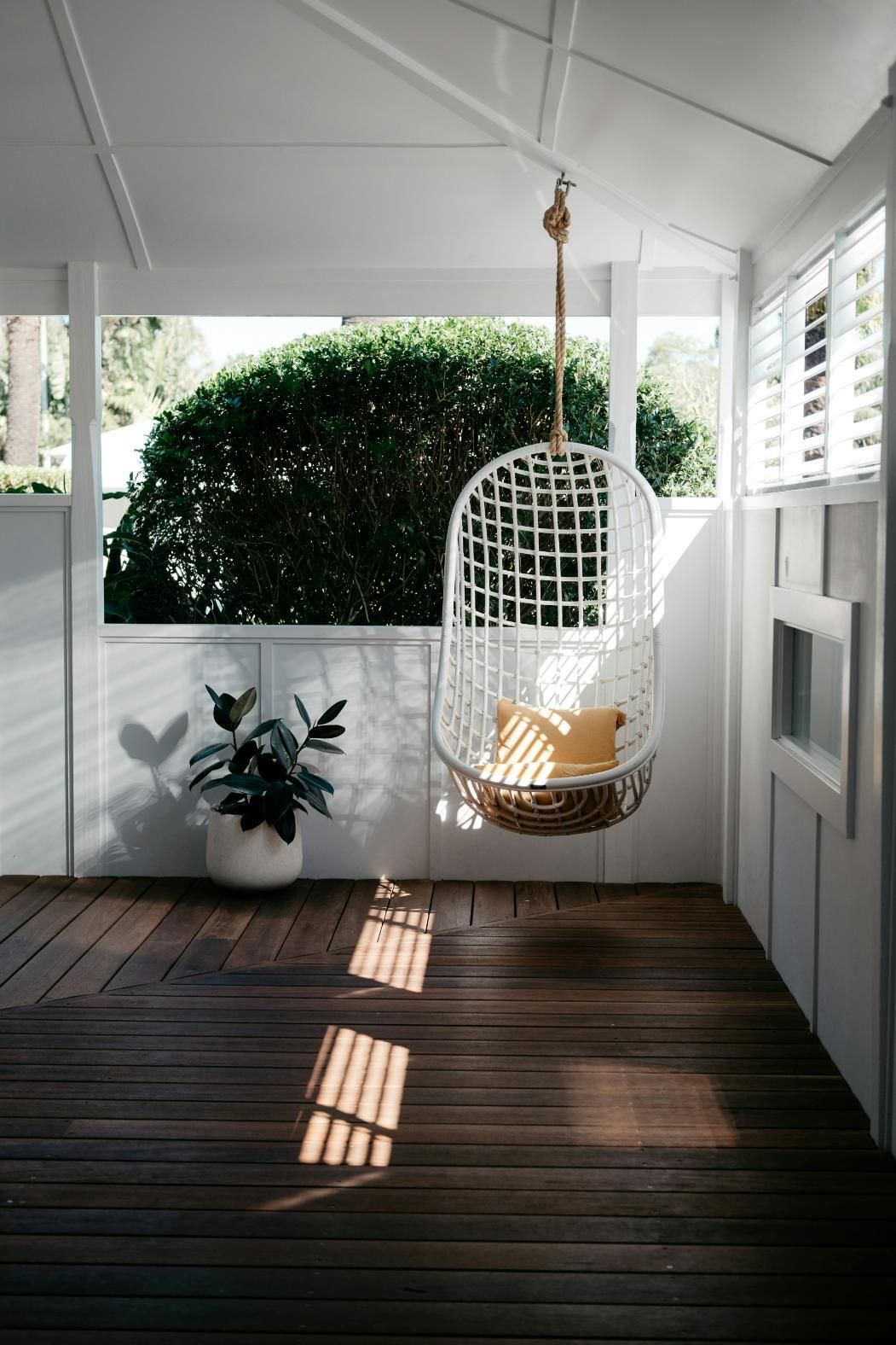 There is a Hanging Chair on the Porch of a House — Slim Fox Home Improvements in Mooroobool, QLD
