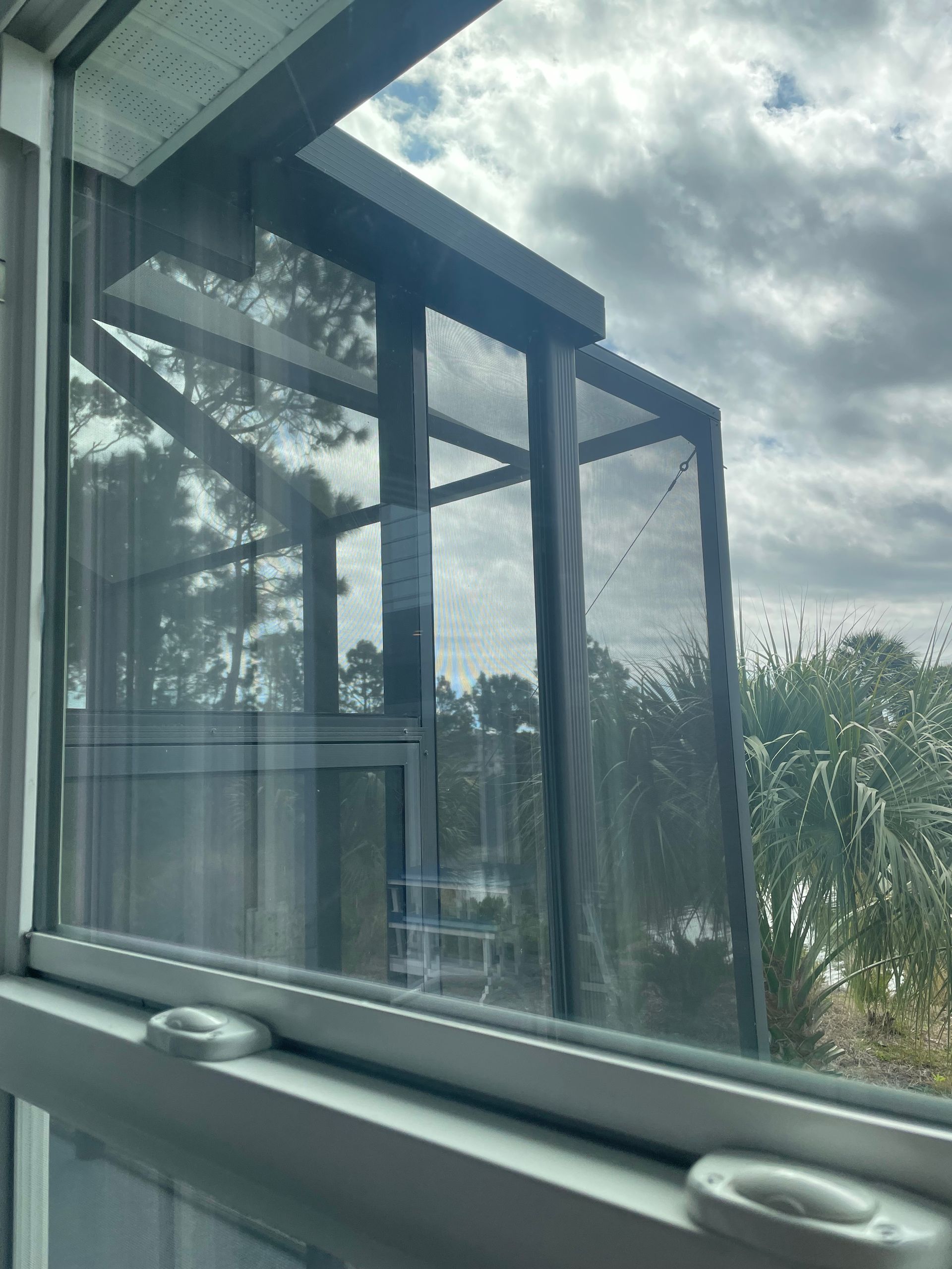 A window with a reflection of a building in it