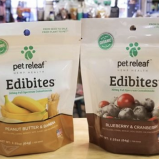 Two bags of Pet Releaf Edibites dog treats: peanut butter banana and blueberry cranberry.