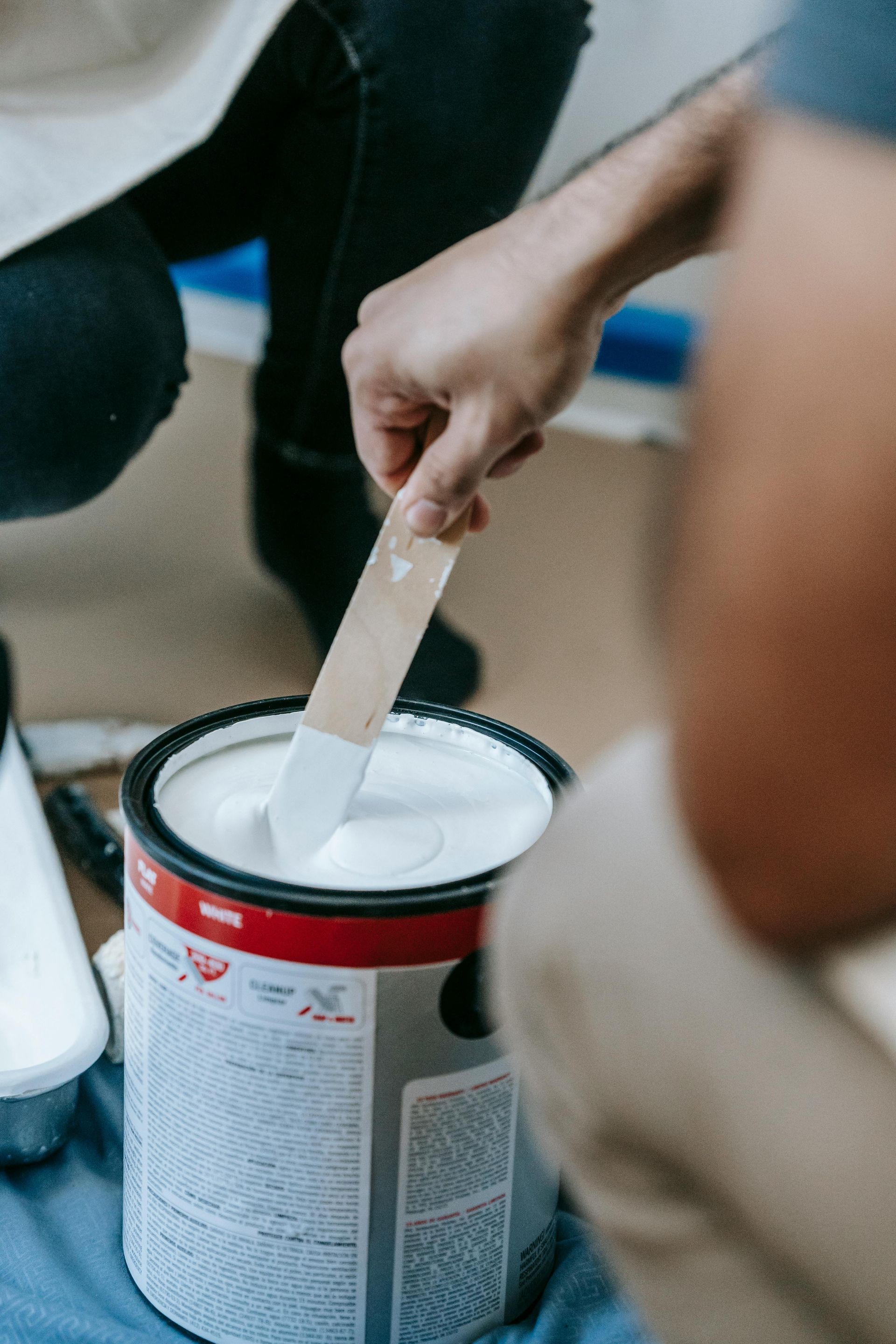 Green Valley Painters paint can mixing showing premium interior and exterior paints for homes and businesses.