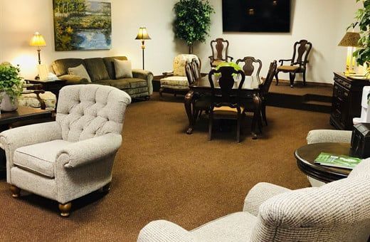 Several Photos of different caskets, gravestones, hearses, interior and exterior views of Kincannon Funeral Home in OK.
