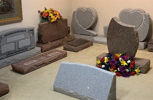 Several Photos of different caskets, gravestones, hearses, interior and exterior views of Kincannon Funeral Home in OK.