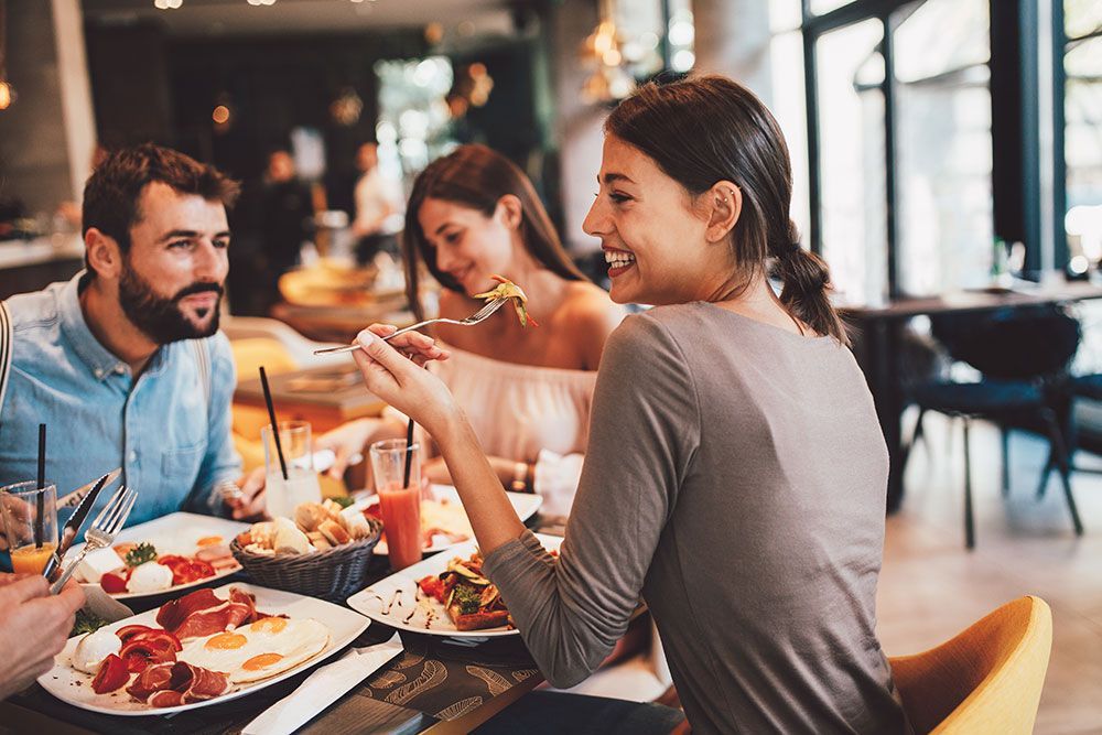 Group of Happy friends having breakfast