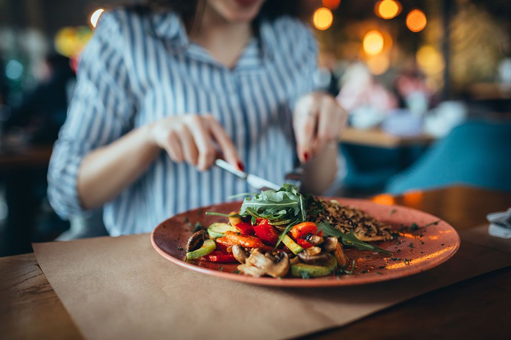 close up of woman in restaurant eating