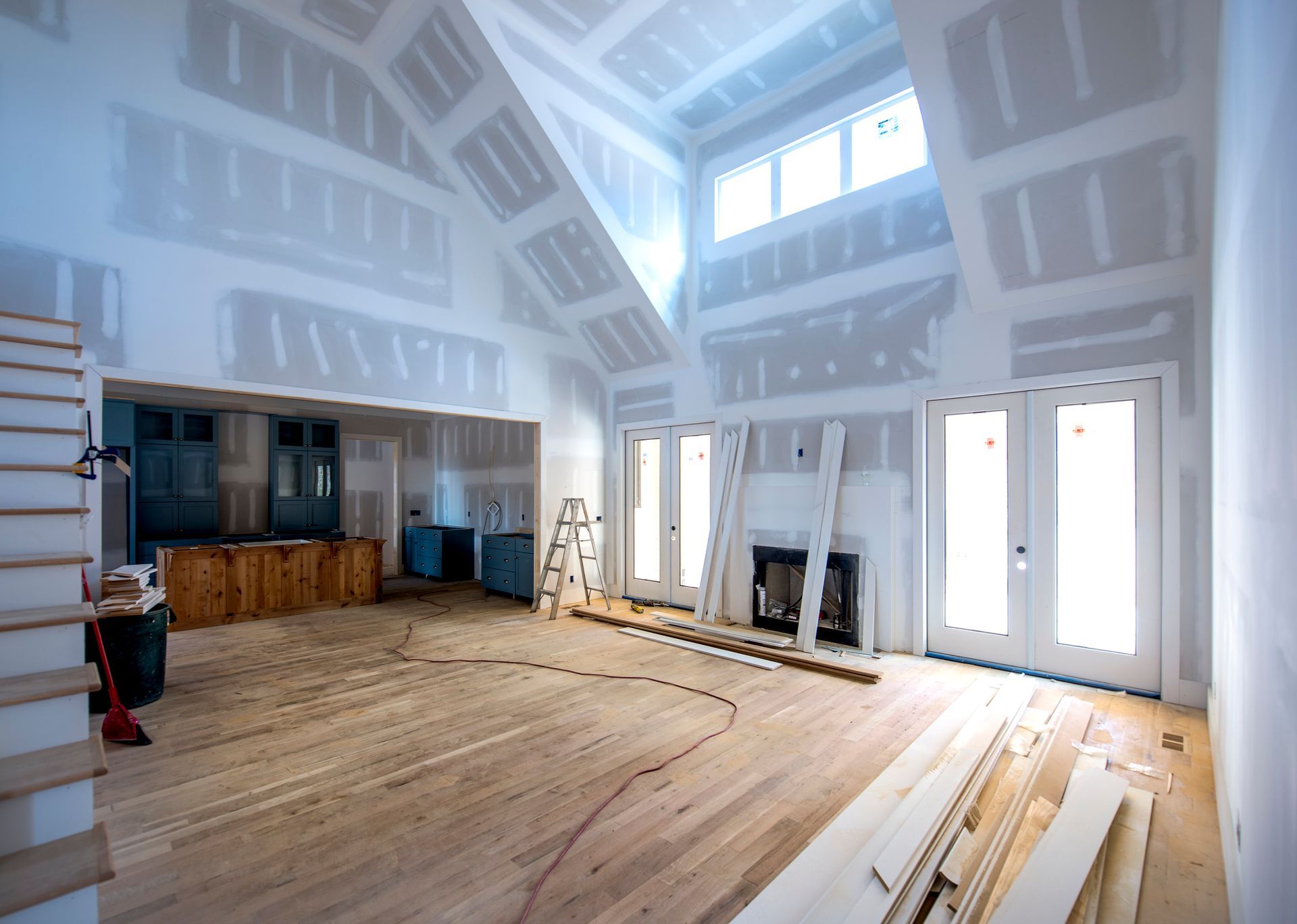 A large room with a vaulted ceiling is being remodeled