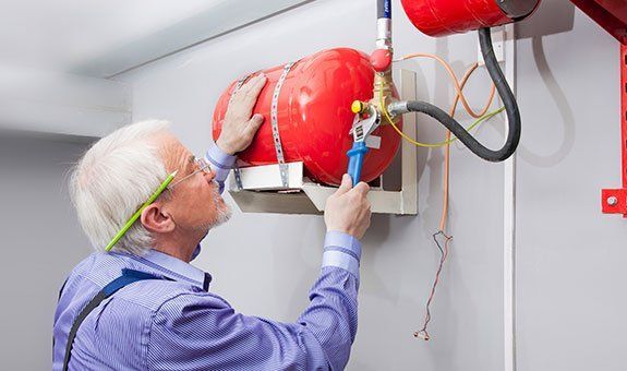 Worker Installing Fire Extinguisher Worker Installing Fire Extinguisher