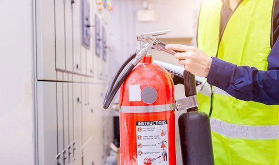 Worker Checking the Fire Extinguisher