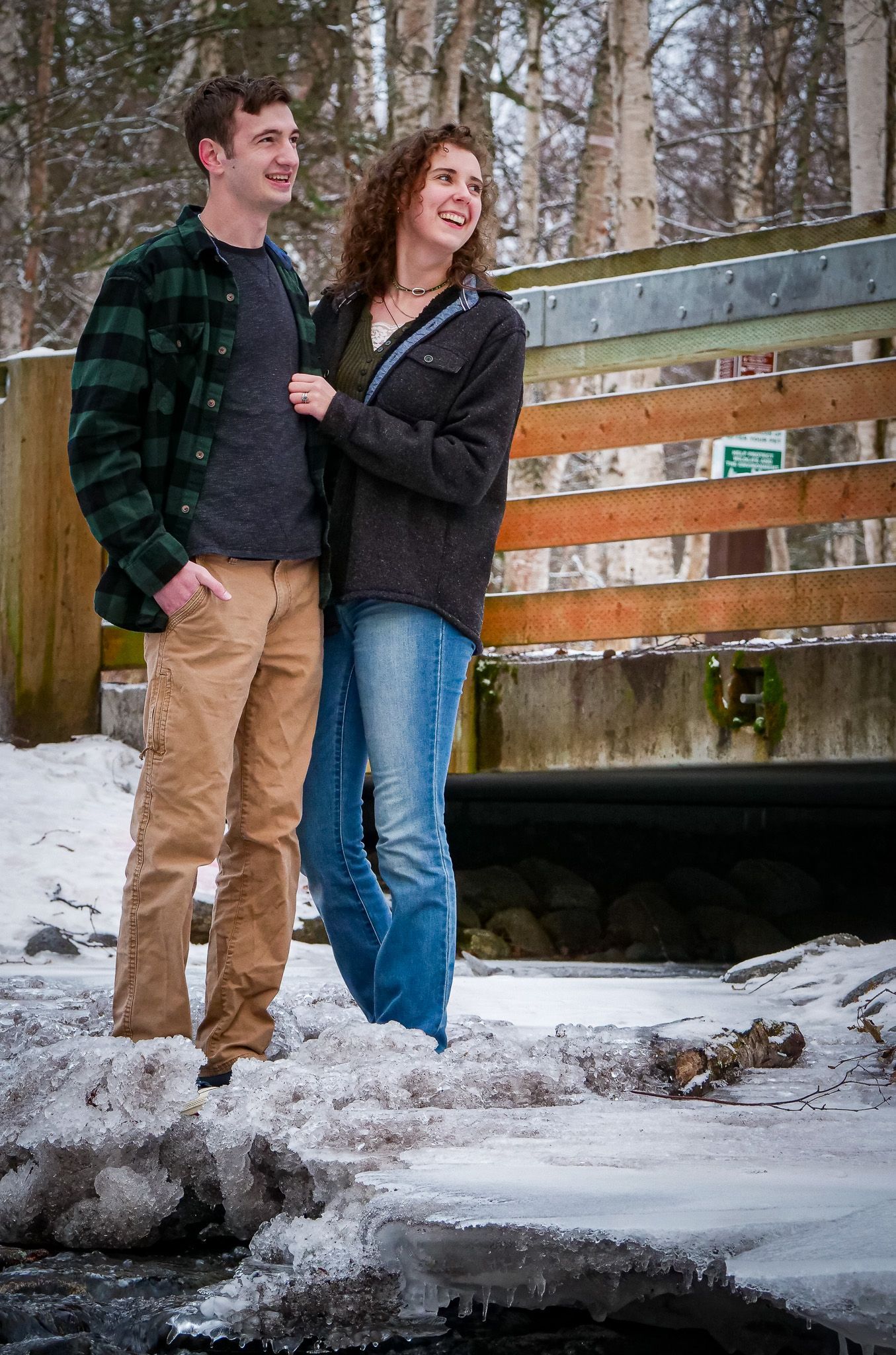 A man and a woman are standing next to each other in the snow.
