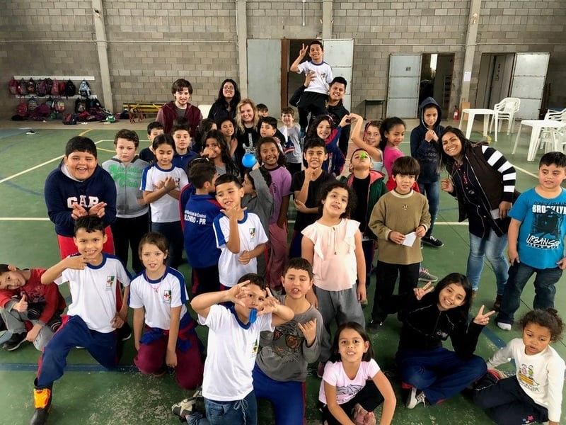 A group of children are posing for a picture in a gym.