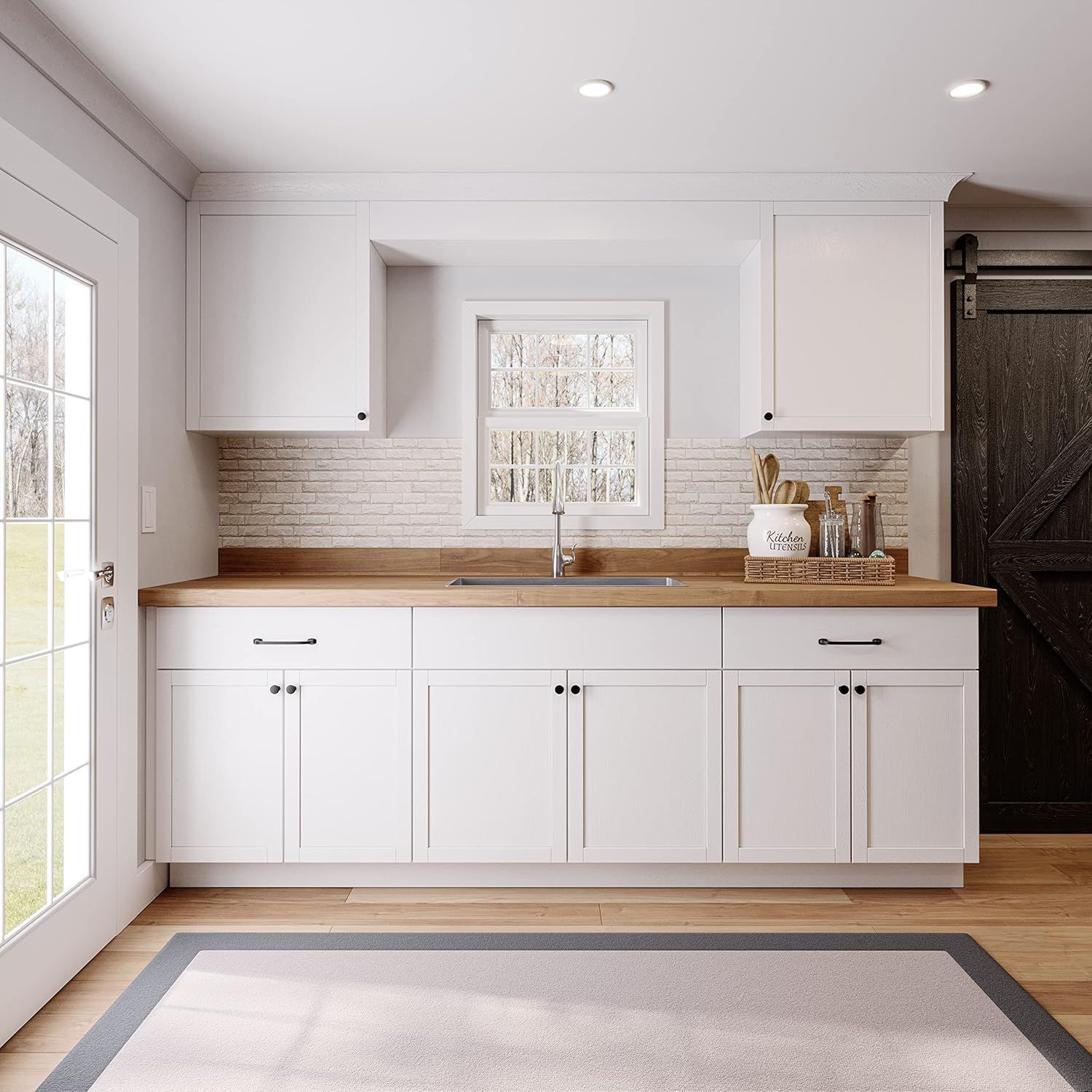 White kitchen with wood countertops, white cabinets, and a barn door.