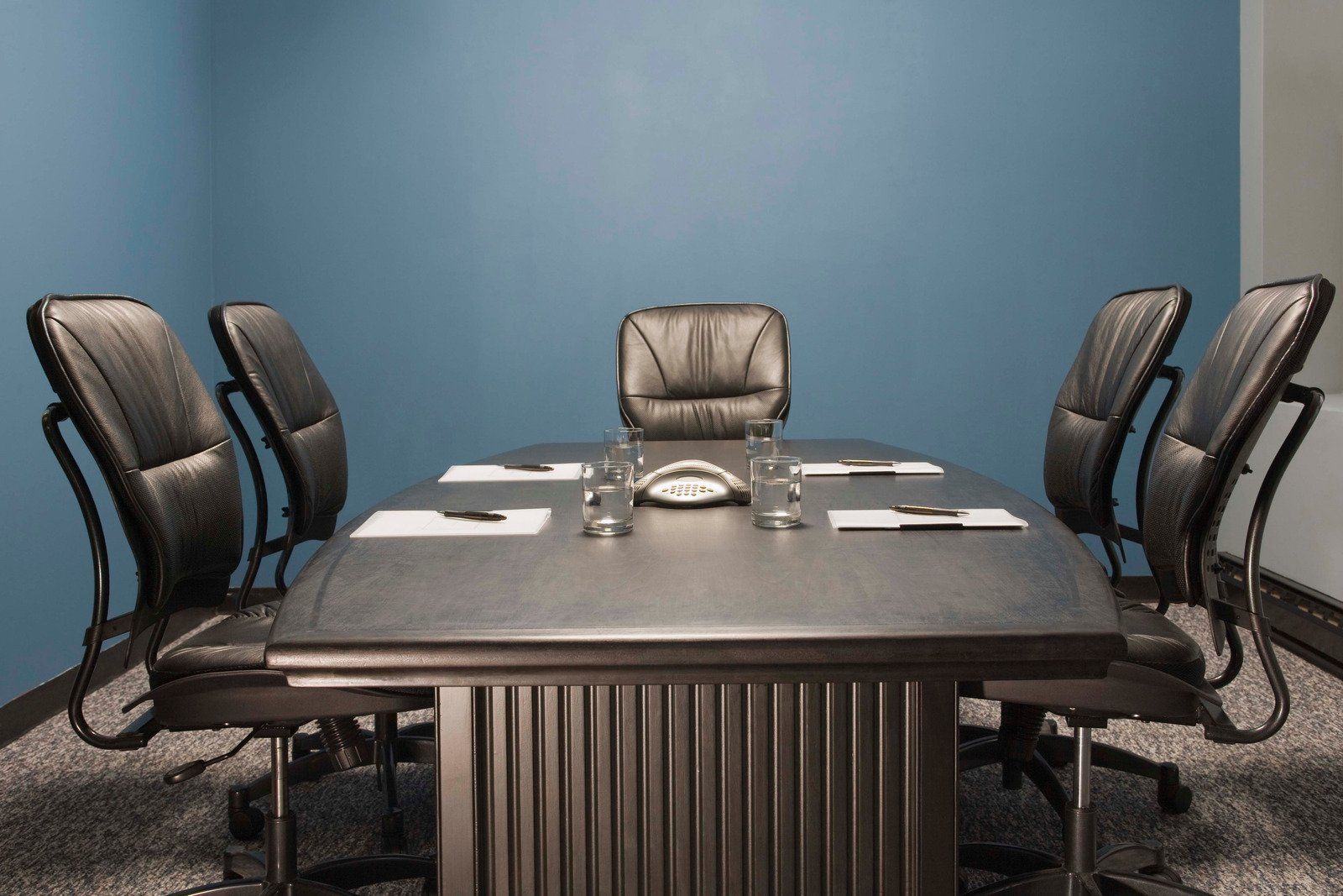 A conference room with a long table and chairs
