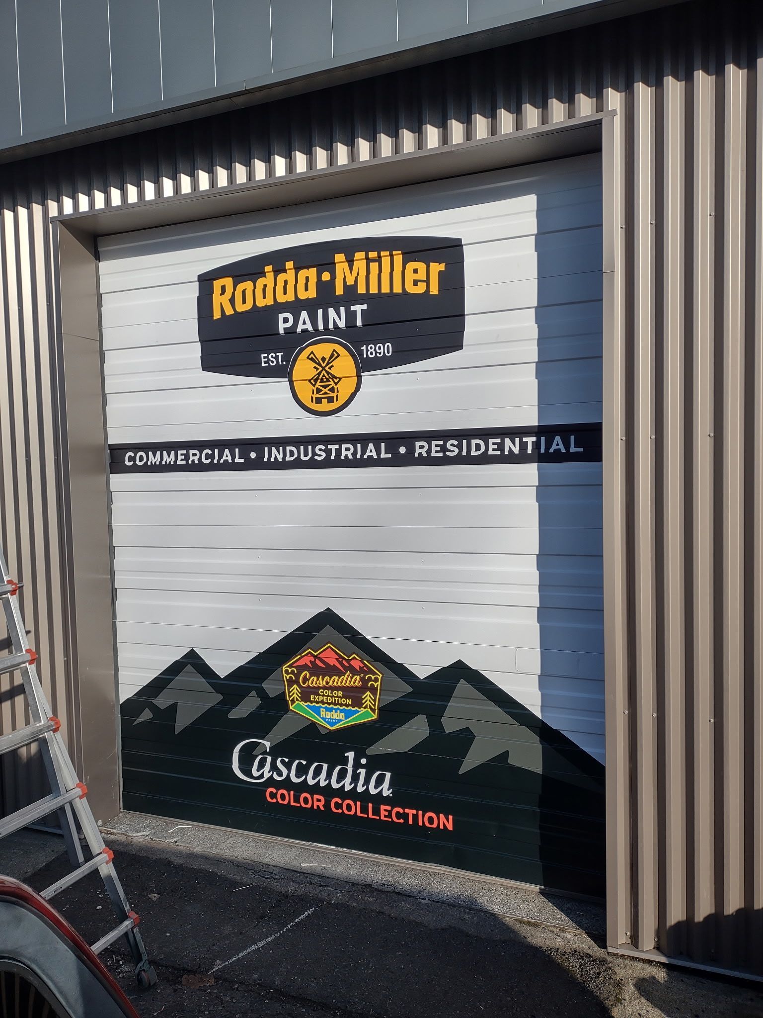 Roller door with Rodda-Miller Paint branding, including a mountain graphic and the Cascadia color collection logo.