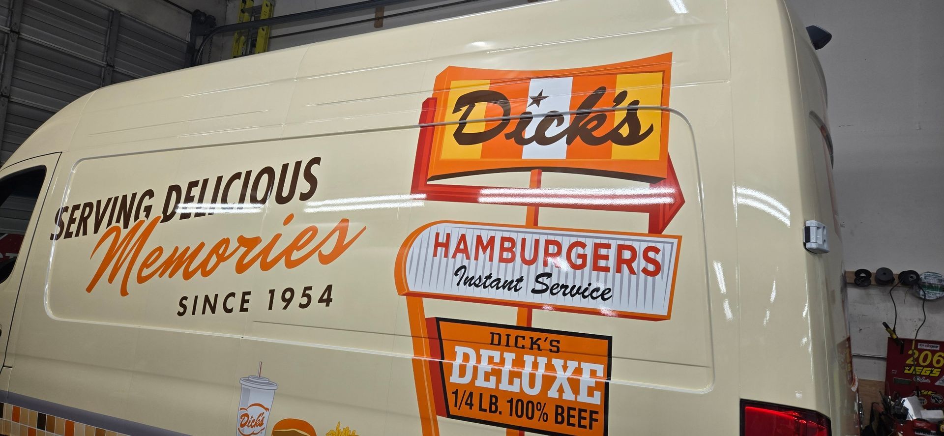 A white Avanti Markets delivery van is parked indoors, featuring brand logos, contact details, and a virtual market display.
