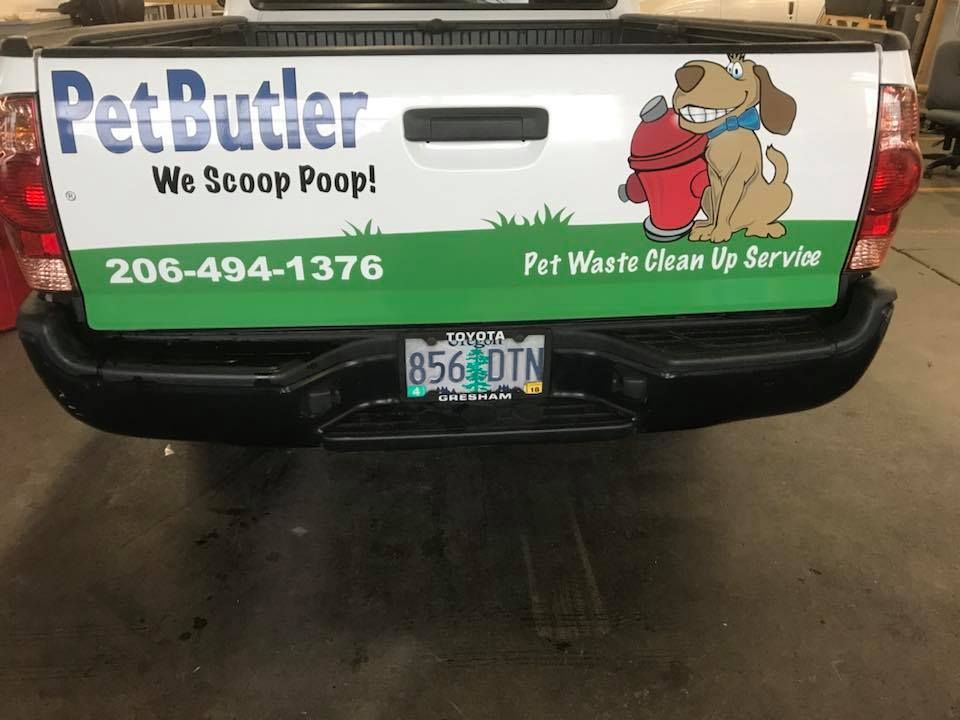 Tailgate of a Pet Butler truck with logo, the slogan