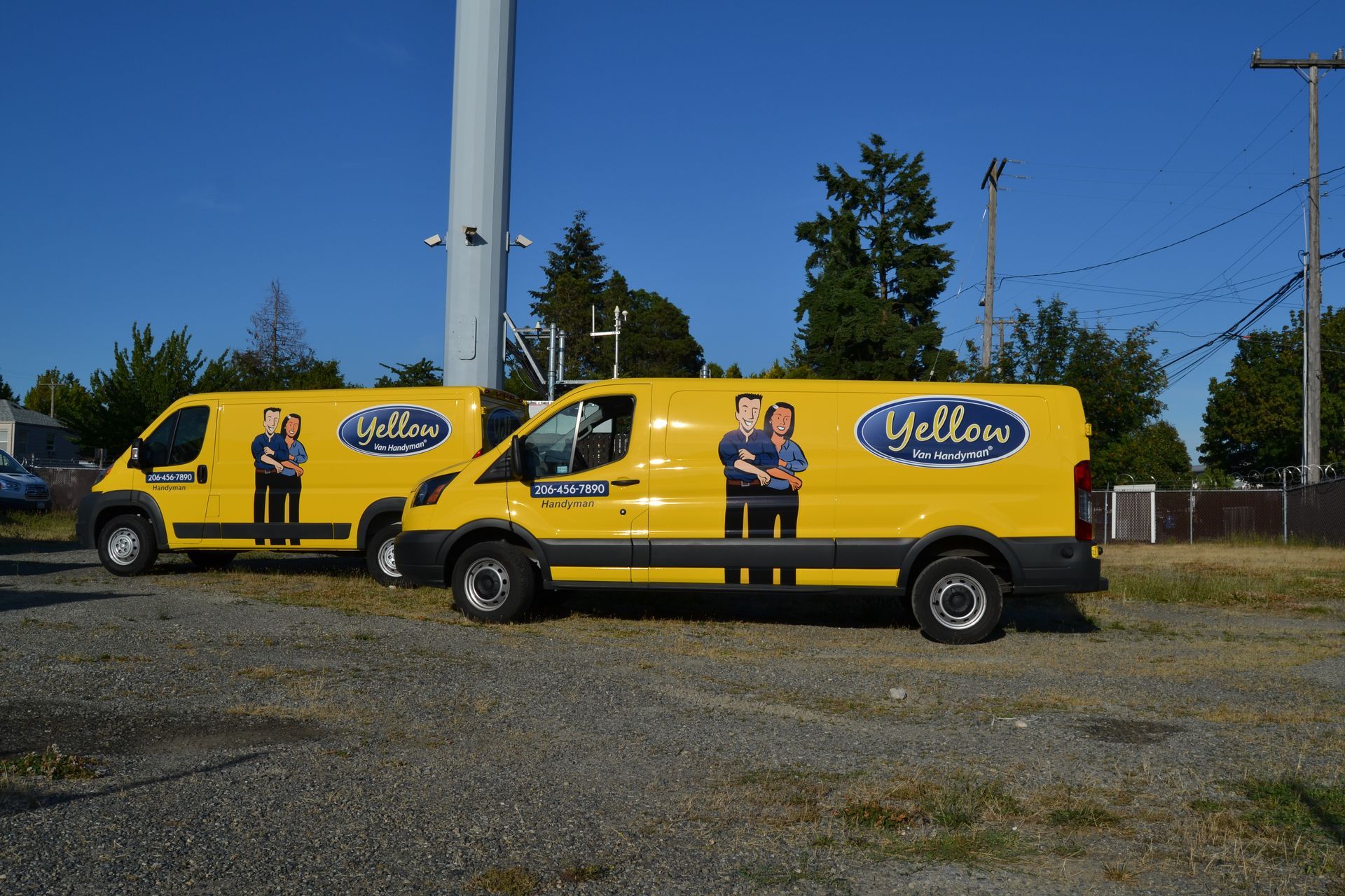 Two bright yellow work vans with 
