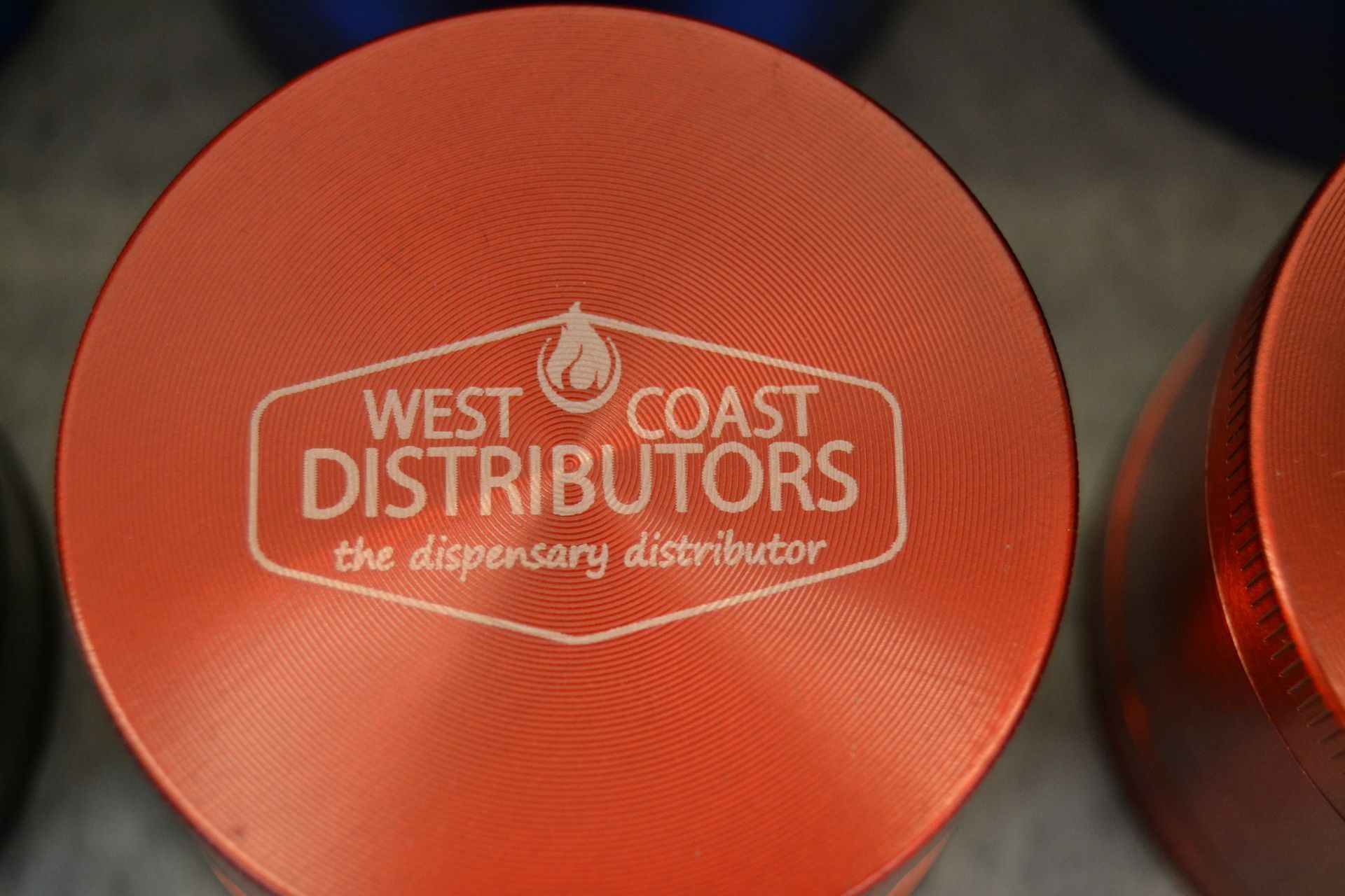 A circular orange metal lid with a white 