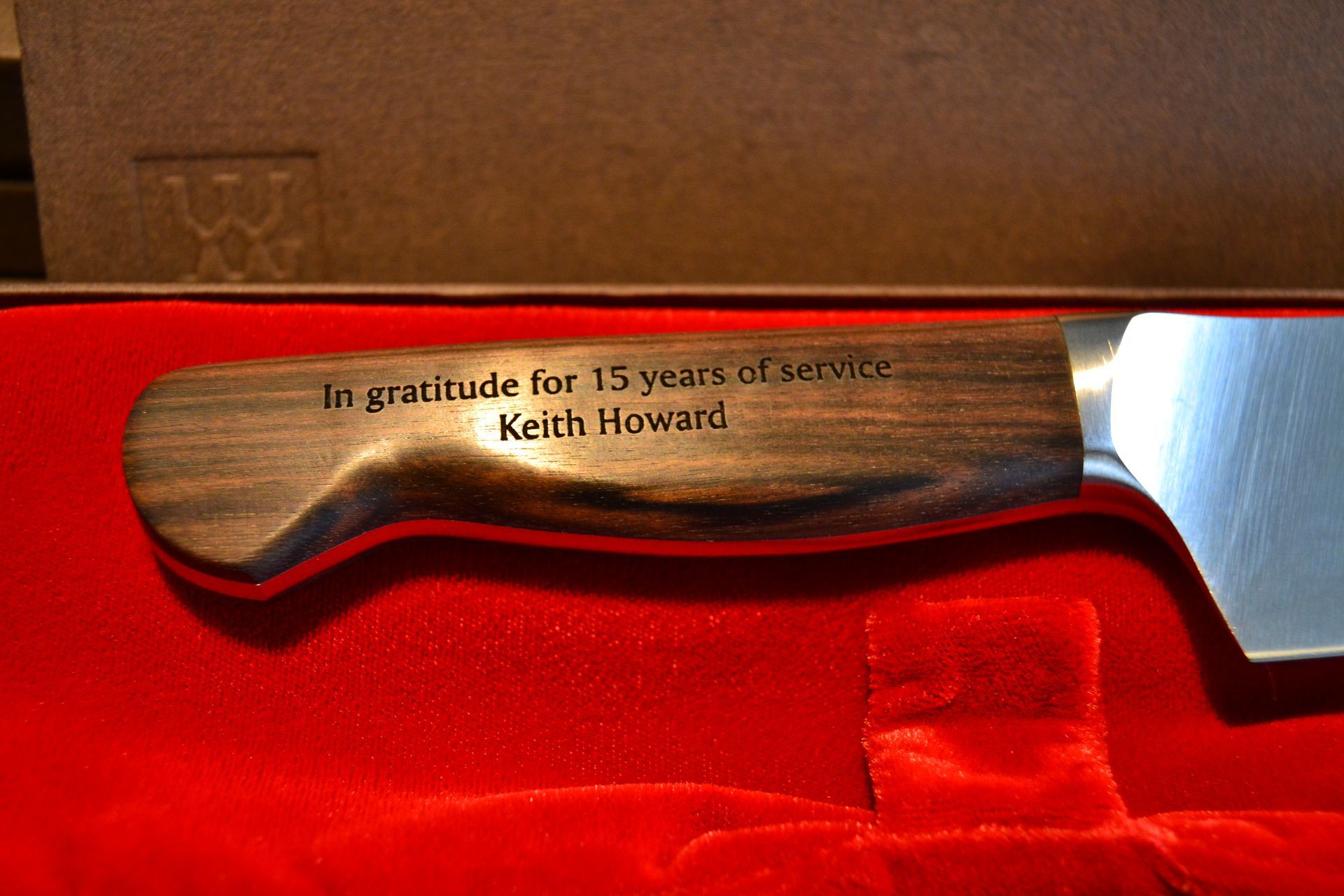 A wooden knife handle engraved with 