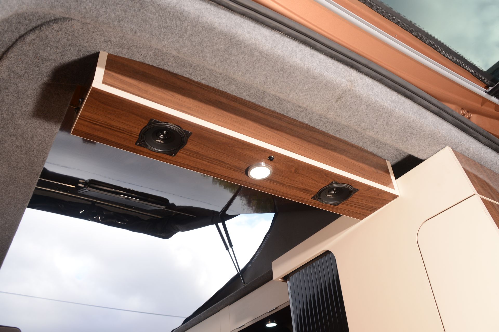 Wood-paneled overhead awning with recessed lights on a building entrance