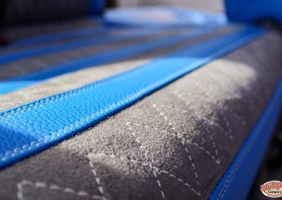 Close-up of a blue and gray quilted mattress or bag fabric with diagonal stitching