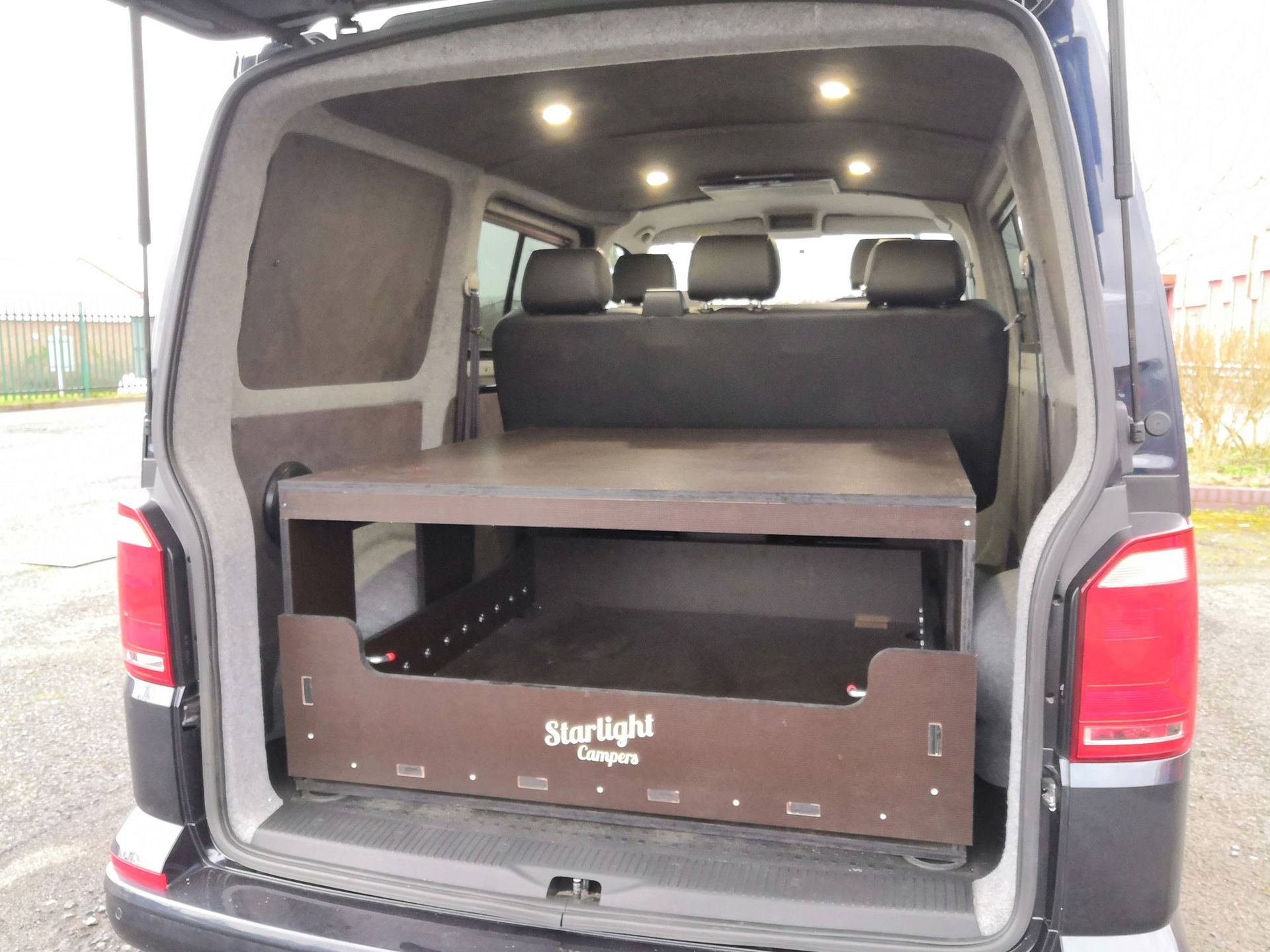Open van cargo van with folded interior shelving and rear doors open