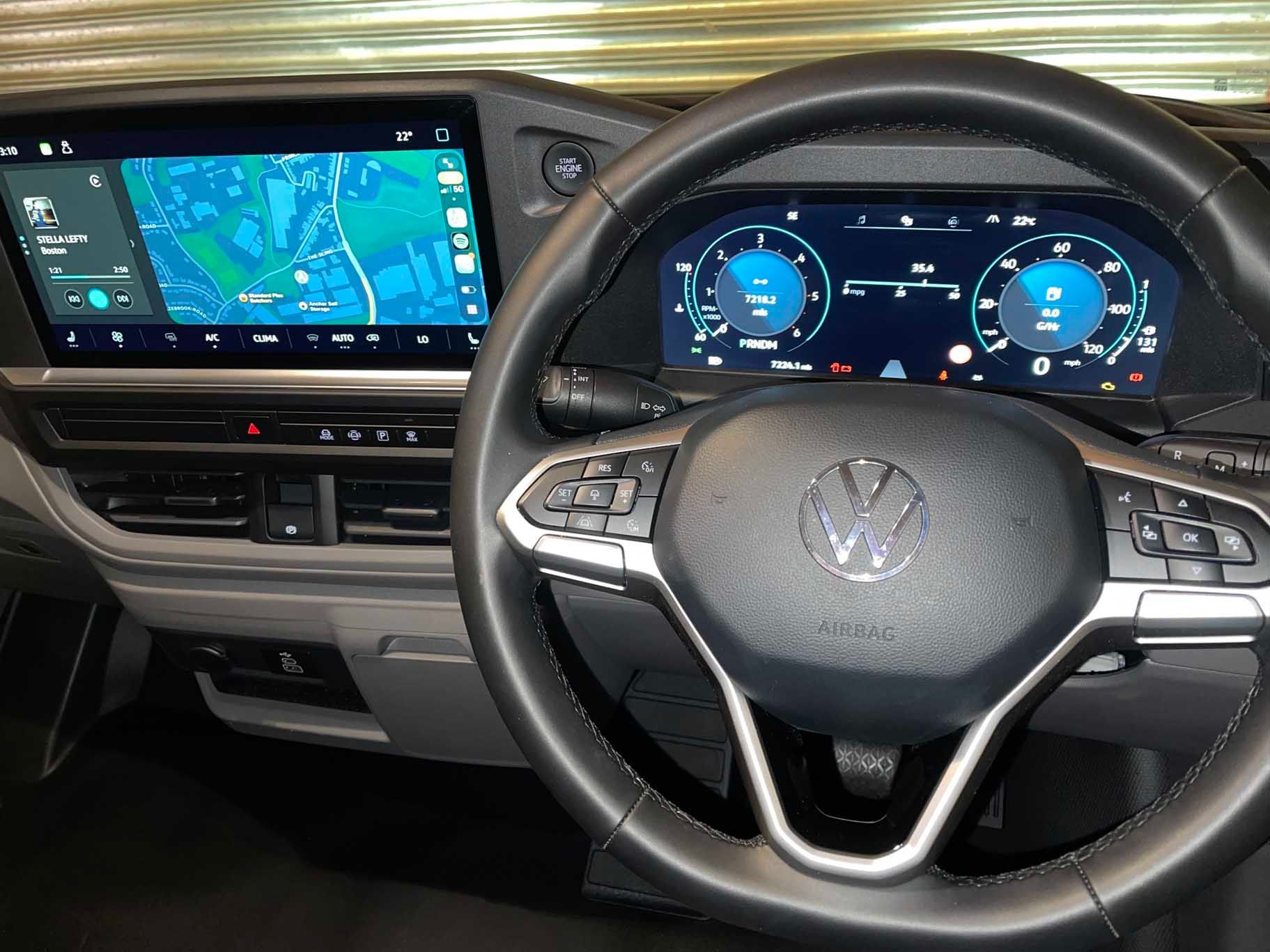 Volkswagen car interior with digital dashboard and infotainment screen displaying navigation map.