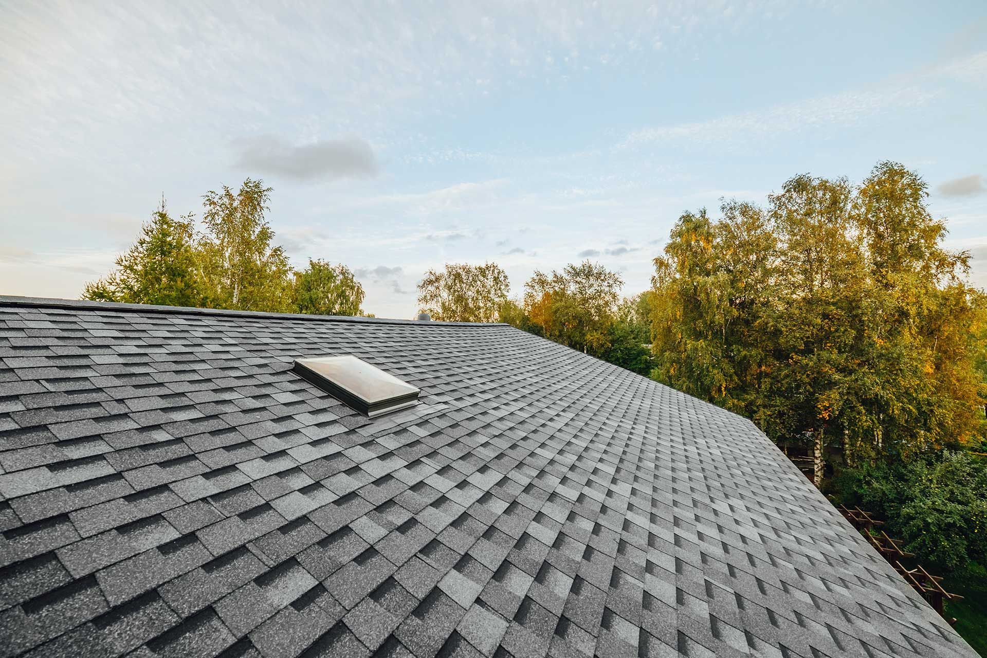 new renovated roof covered with shingles flat polymeric roof-tiles 
