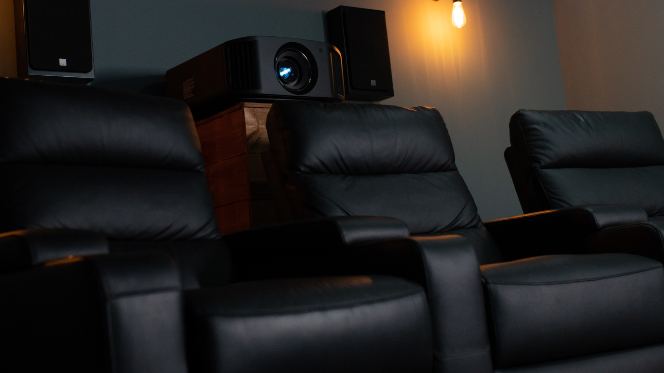 A row of brown leather seats in a theater