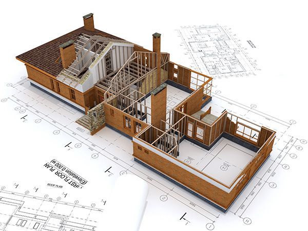 A model of a house is sitting on top of a blueprint.