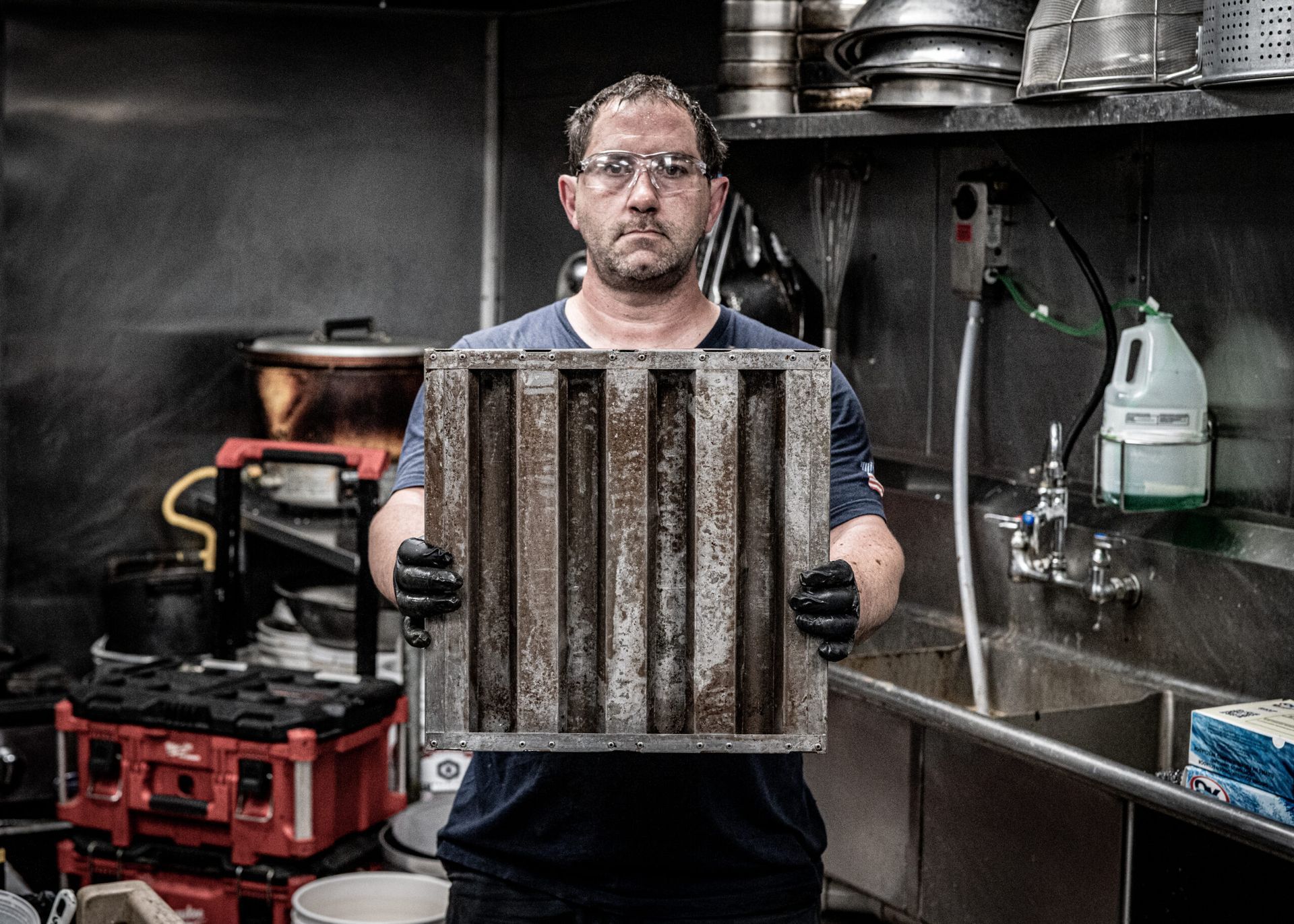 A Man Is Holding a Dirty Filter in A Kitchen | S. Glens Falls, NY | Performance Industrial