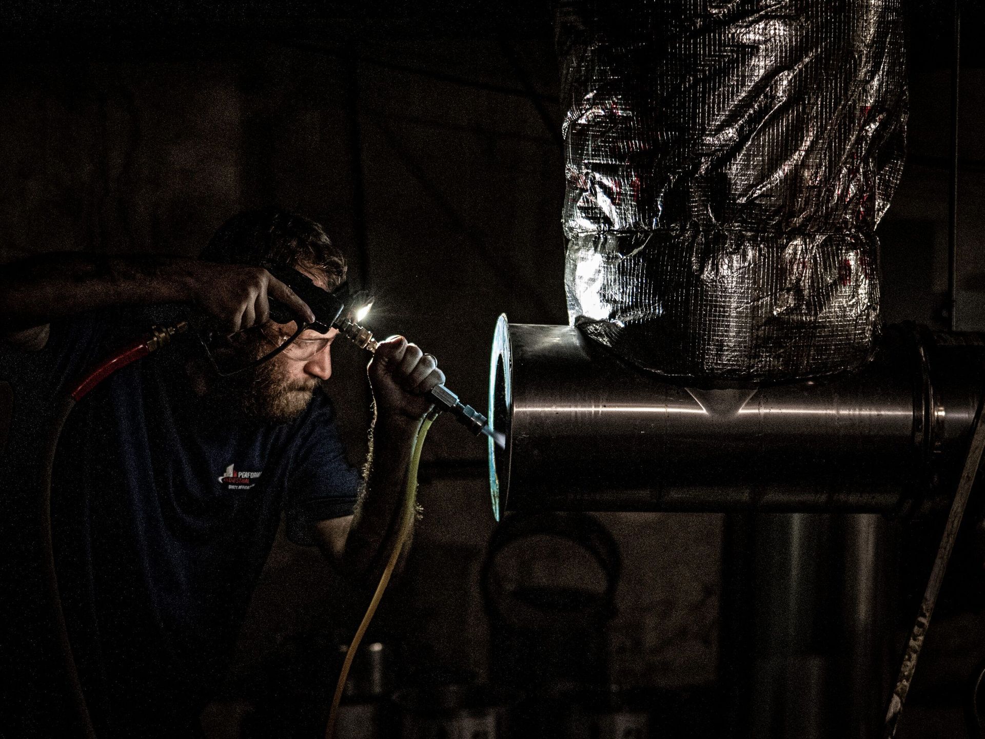 A Man Is Welding A Piece Of Metal | S. Glens Falls, NY | Performance Industrial
