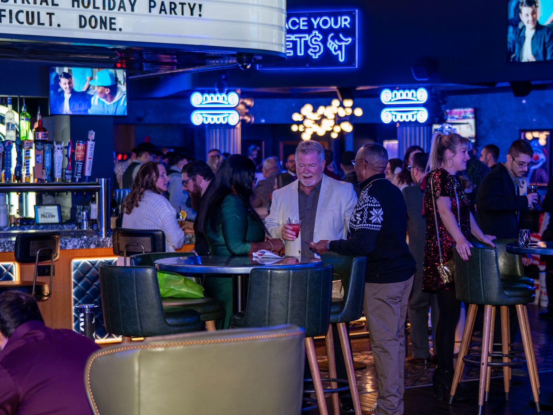 Employees mingling in a large event space during Performance Industrial’s holiday appreciation party featuring a private bar, entertainment, and a full venue celebration.
