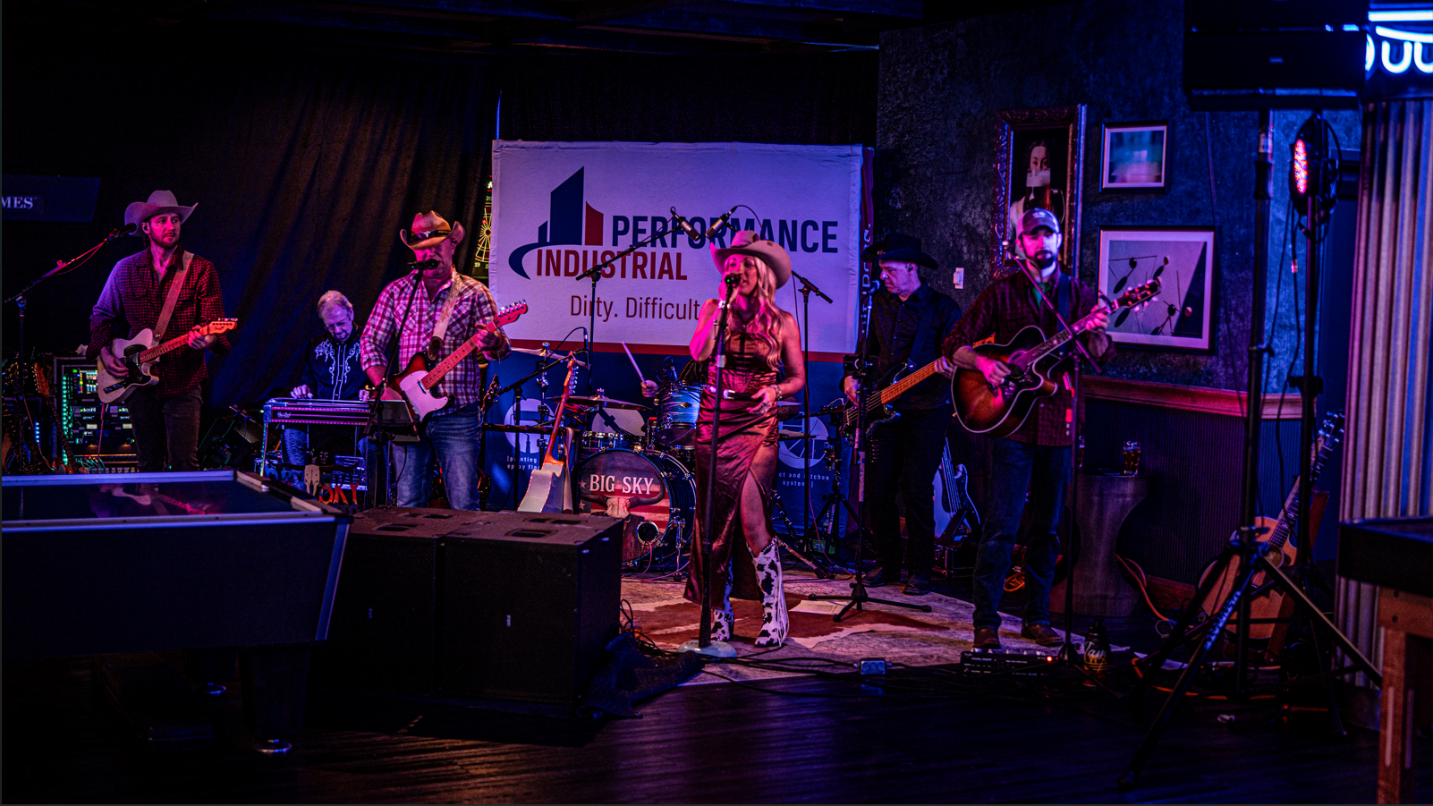  Live country band performing on stage at Performance Industrial’s annual employee appreciation holiday party in a rented venue with professional lighting and full sound setup.
