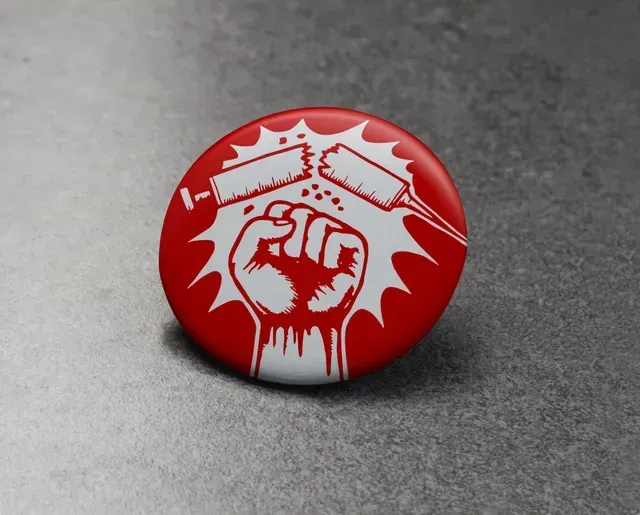 A red button with a fist and syringes on it