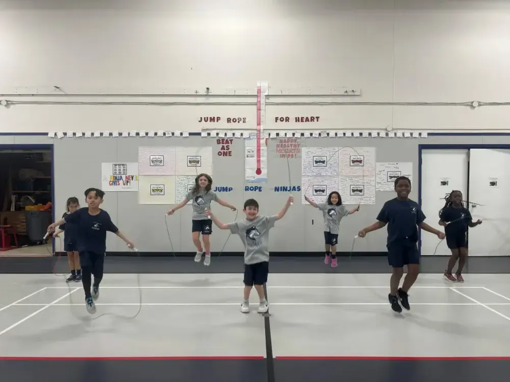 Children jumping rope in a school gym