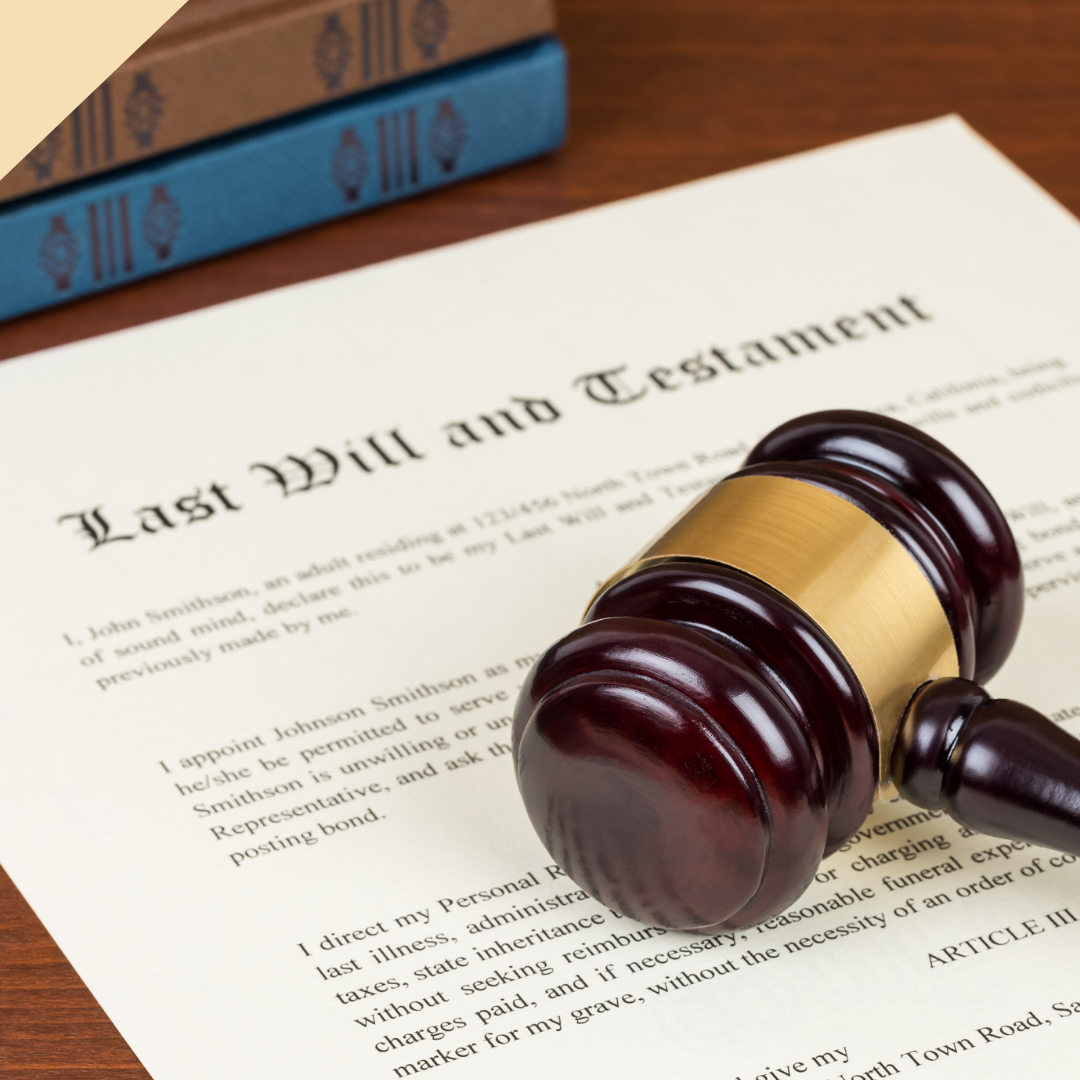 A Last Will and Testament document with a gavel resting on it; books in background.
