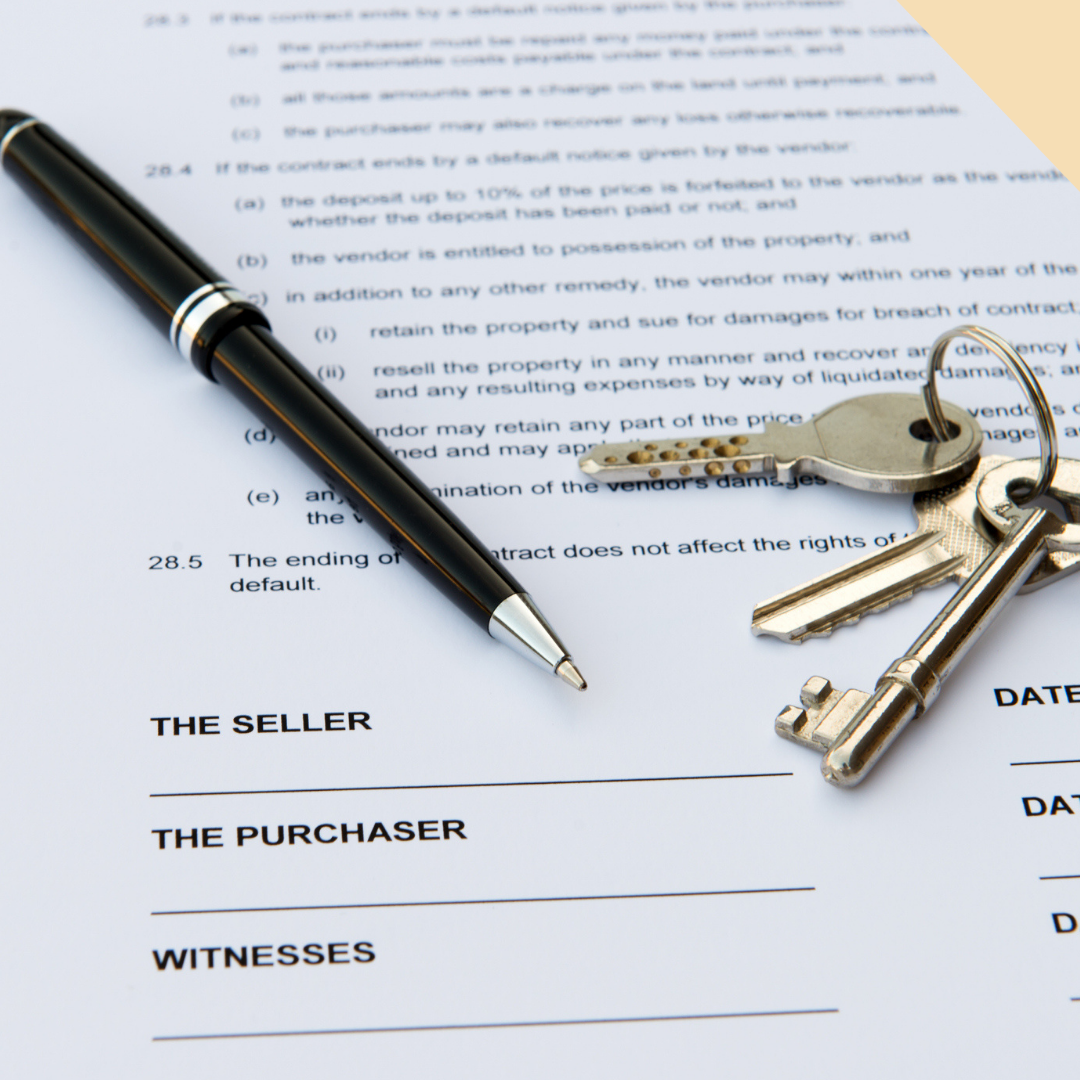 Pen and keys on a real estate contract, ready to be signed.