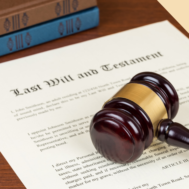 Last Will and Testament document with a gavel and books on a wooden surface.