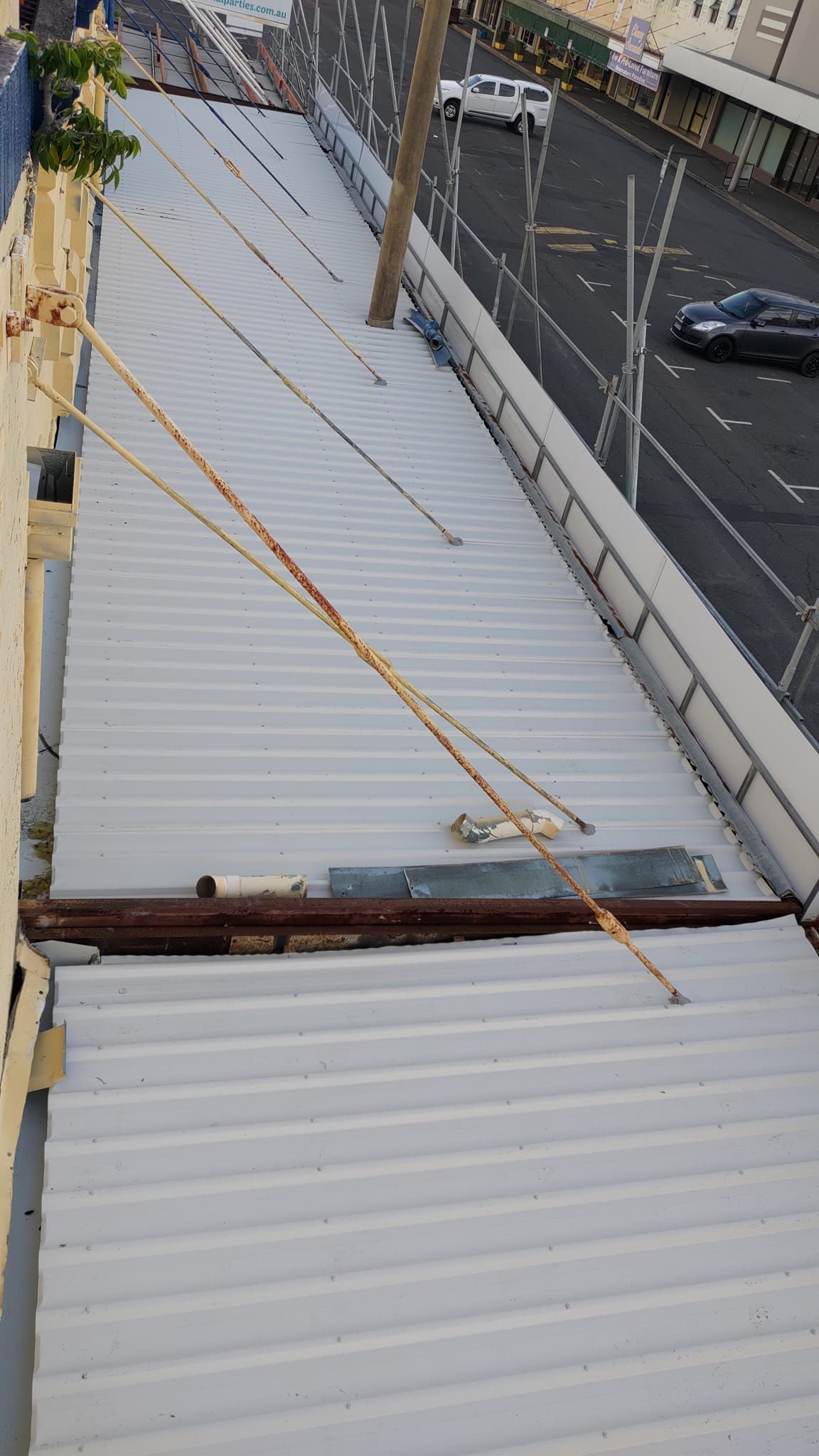 A High-angle View of a Grey Corrugated Metal Roof — Rhettro Roofing Industry in Taroomball, QLD