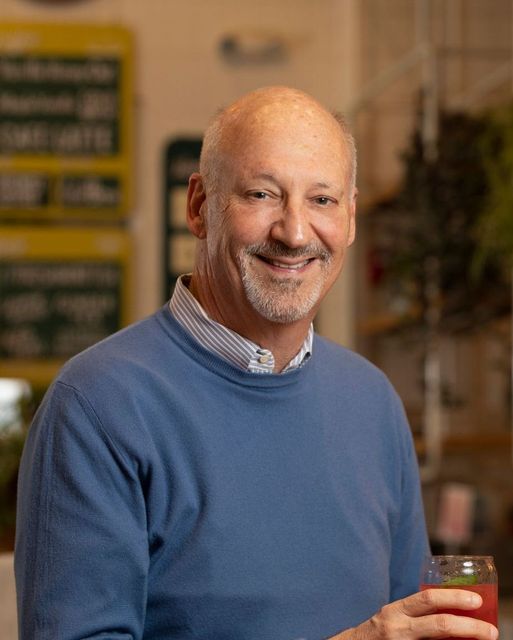 a photo of Ron Shaich holding a cup