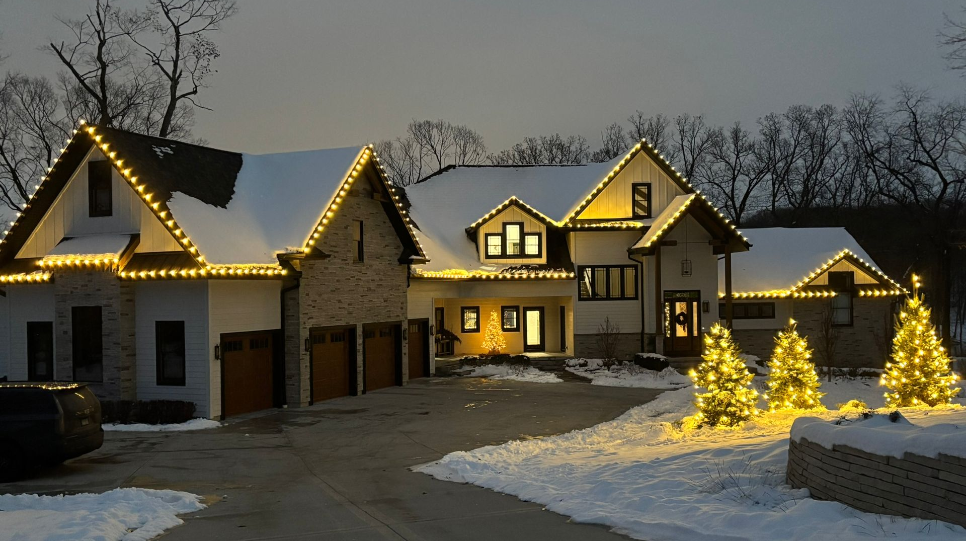 Warm white C9 Christmas light installation on a two story home by Green Pro Services