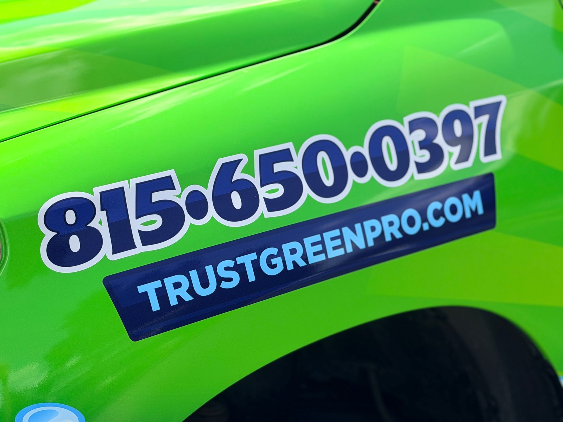Side view of the new Green Pro Services work truck wrap showing the roof cleaning and house washing design