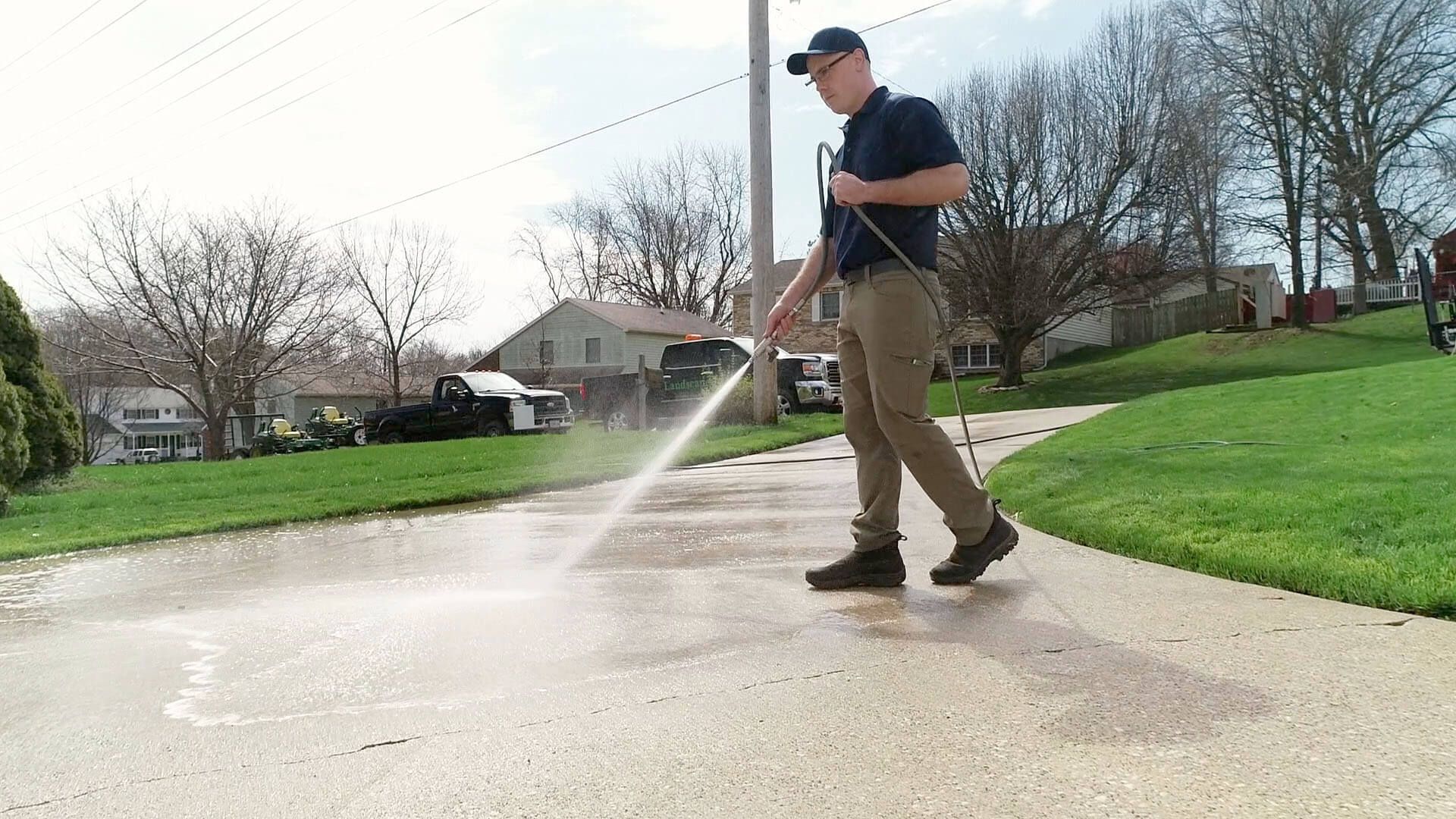 Green Pro Services pressure washing a concrete driveway in Cook County, Illinois
