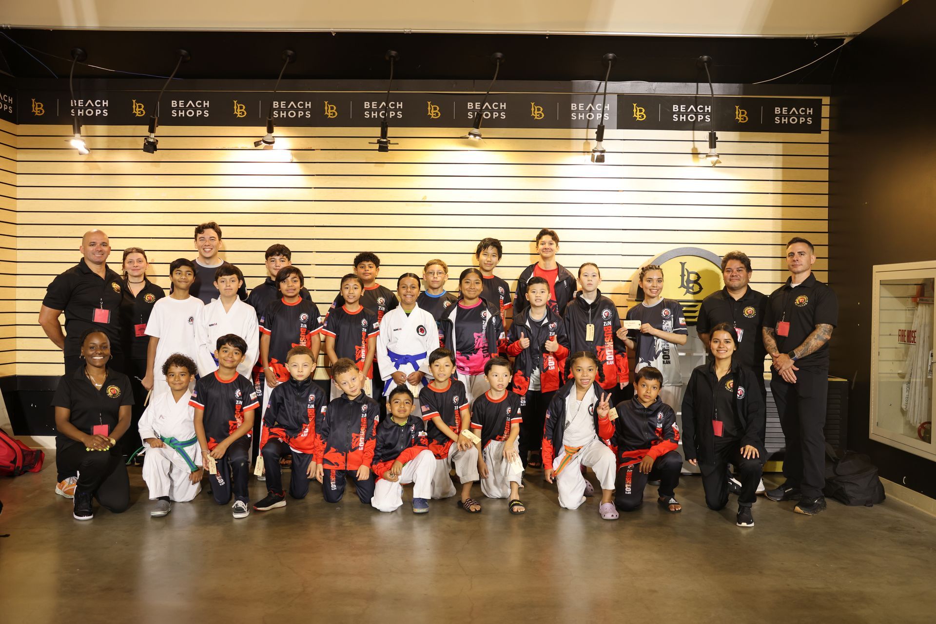 Group of people in matching jerseys posing indoors for a team photo